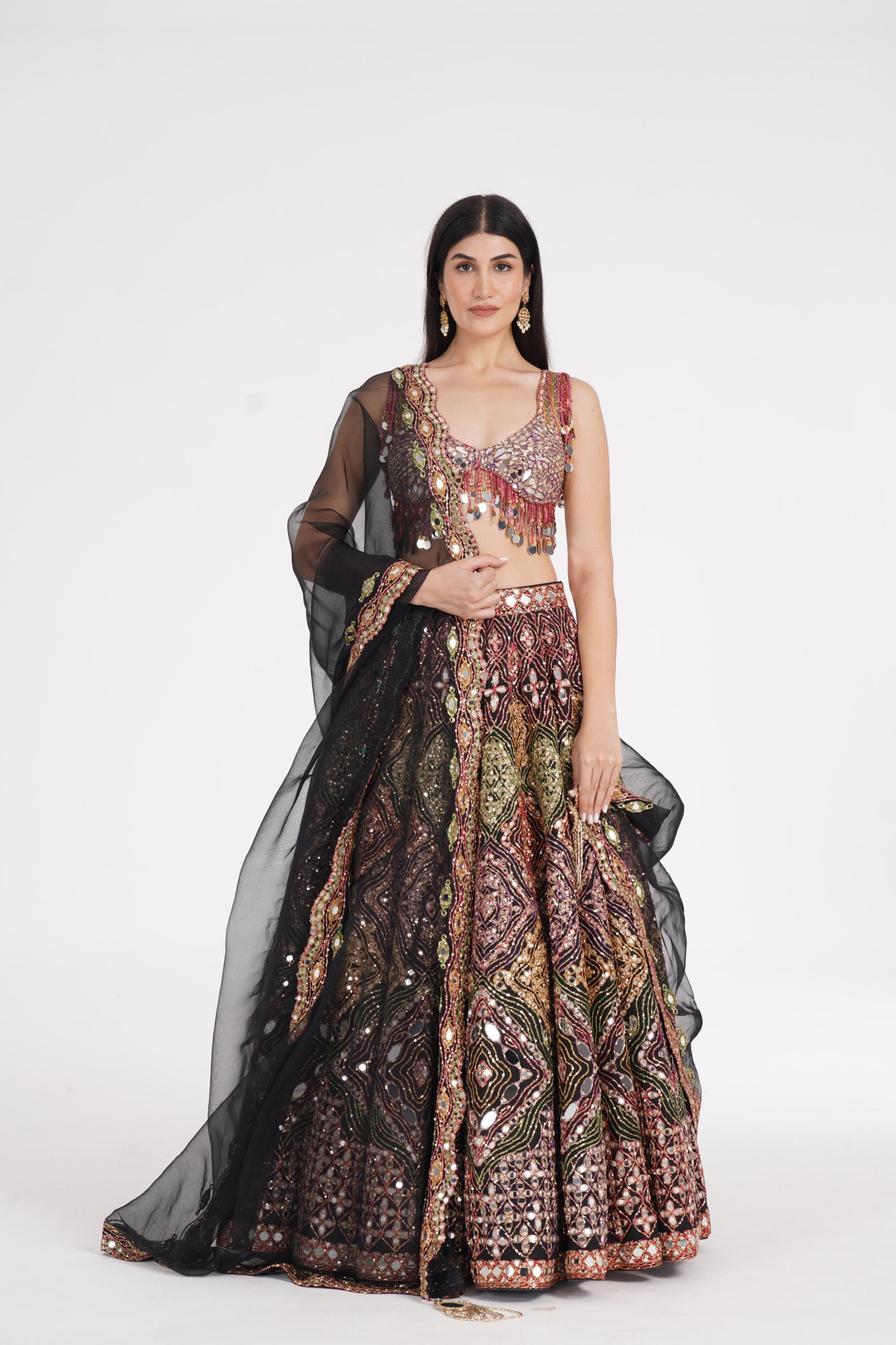 Matte black lehenga embellished using warm pastels