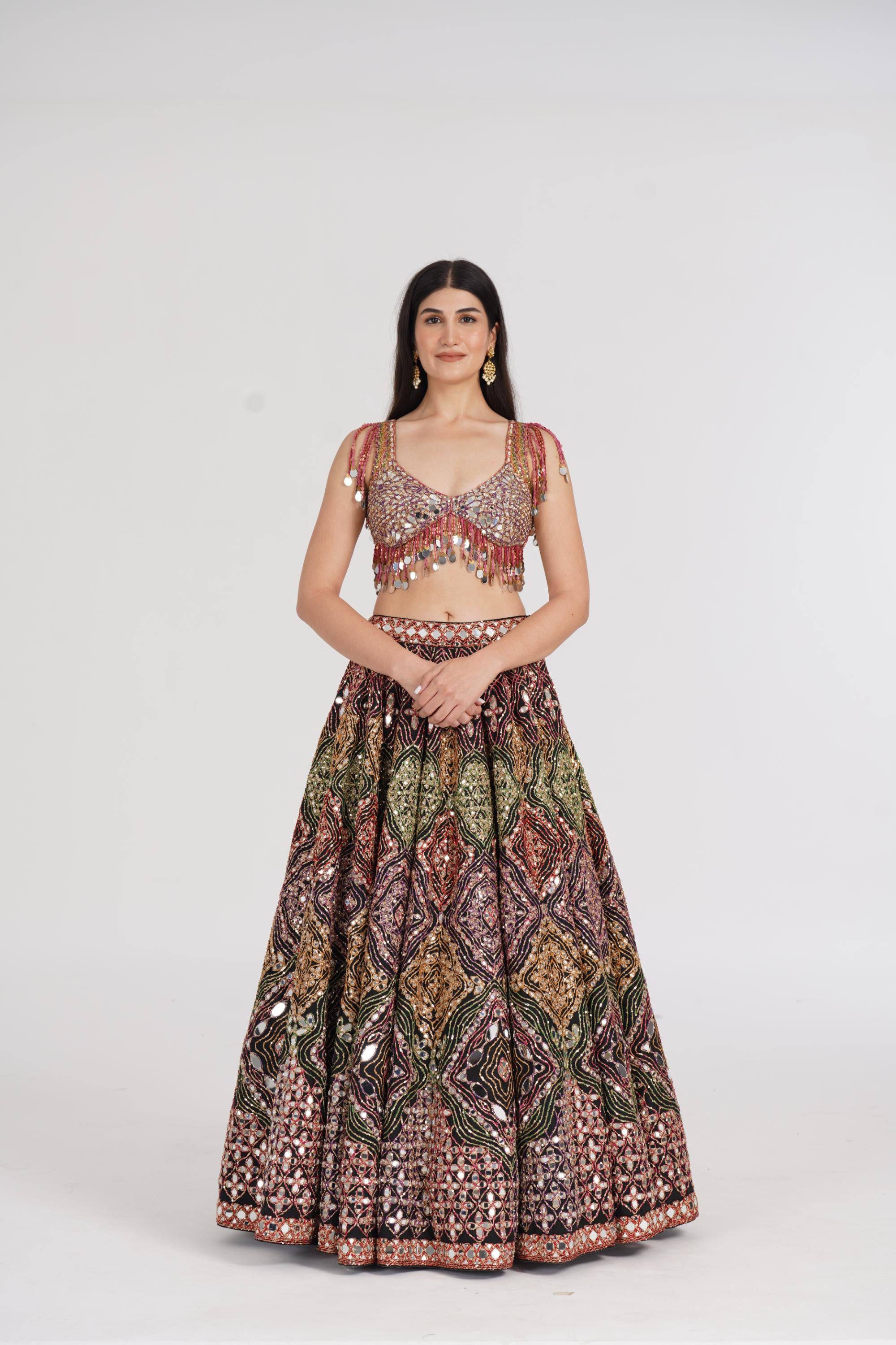 Matte black lehenga embellished using warm pastels