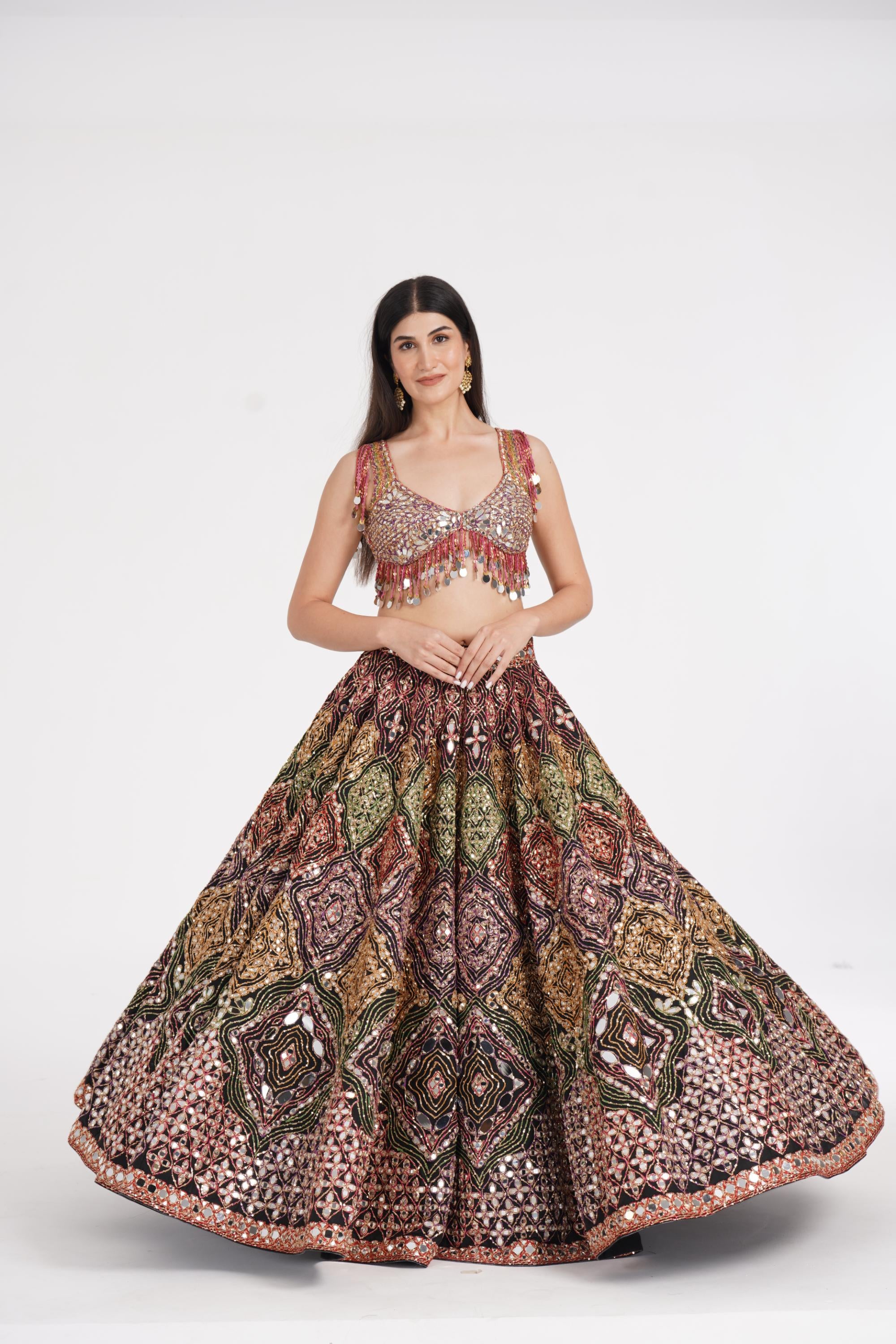 Matte black lehenga embellished using warm pastels