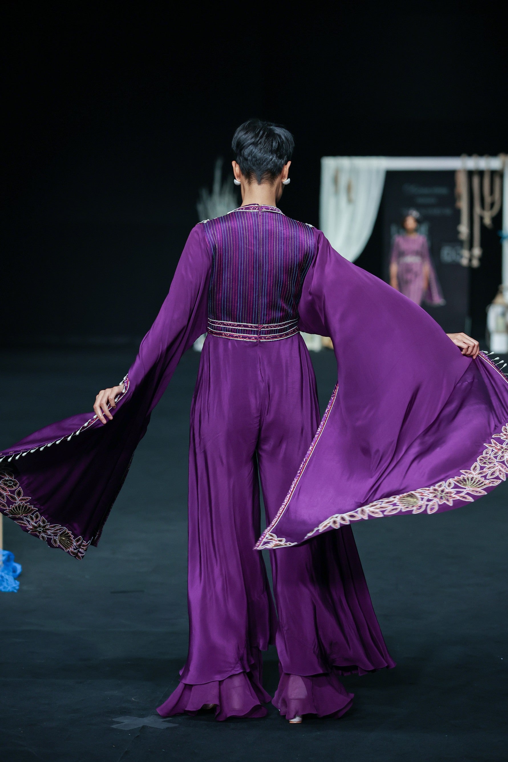 Purple heavily embellished jumpsuit with embroidered cape sleeves