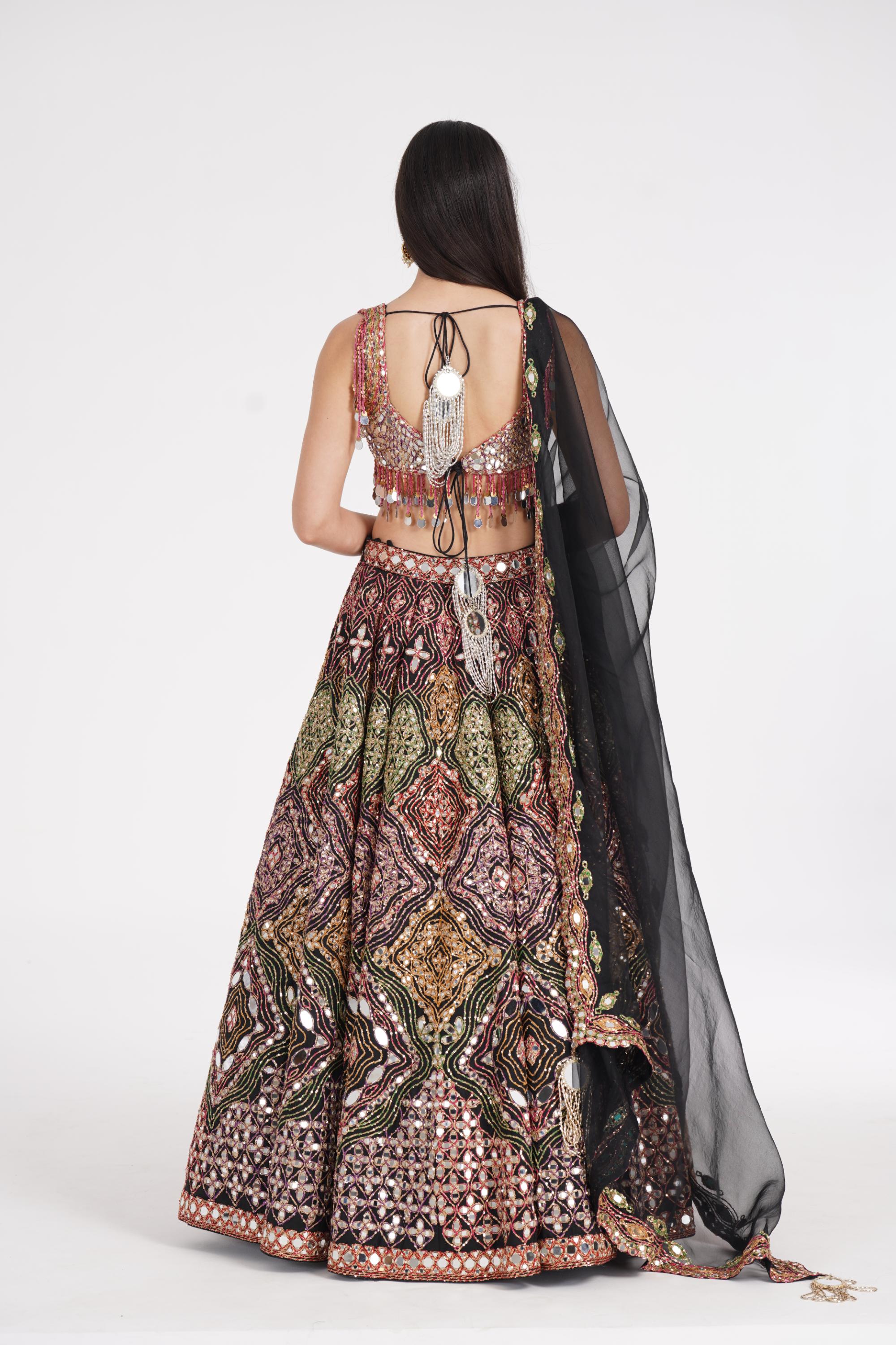 Matte black lehenga embellished using warm pastels