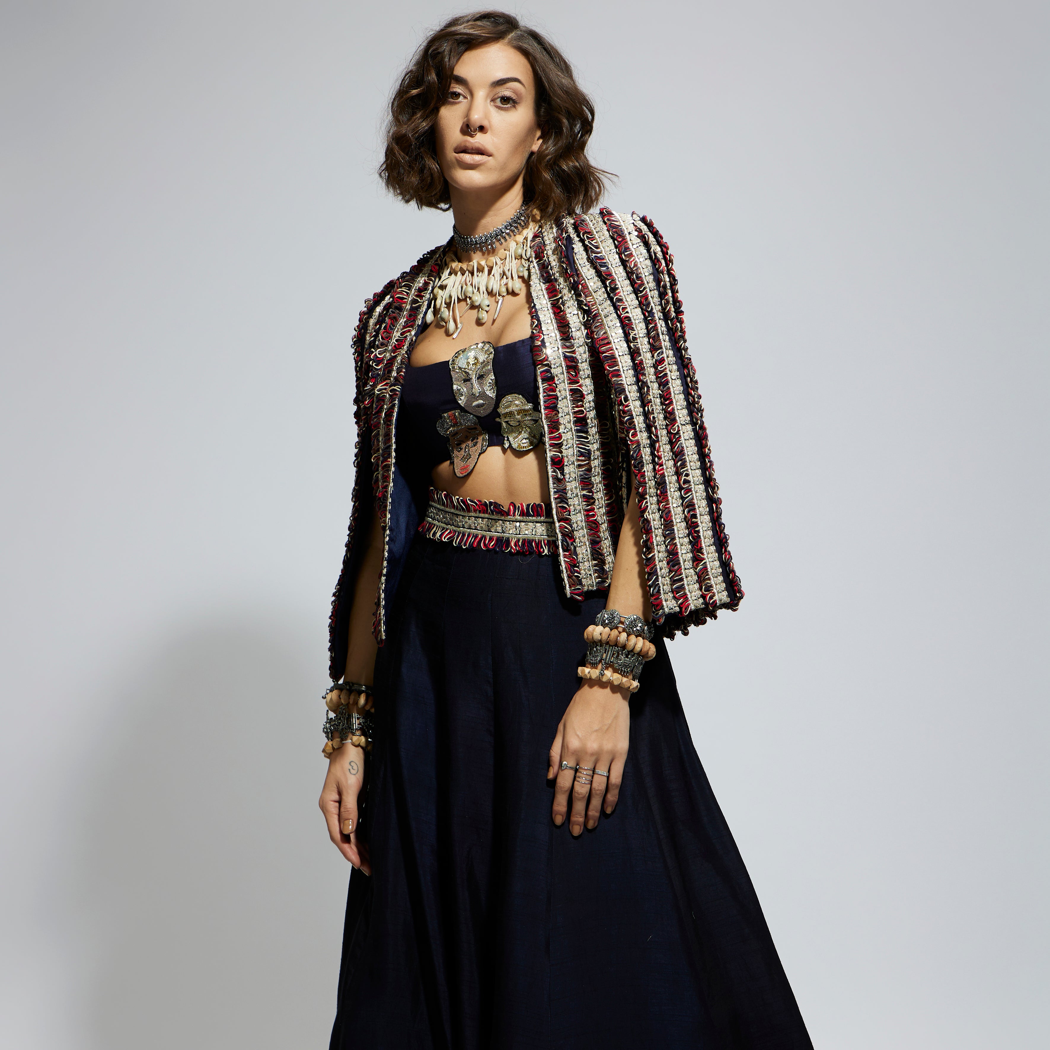 BLUE TEXTURED EMBELLISHED CAPE JACKET PAIRED WITH MASK APPLIQUE BUSTIER AND LEHENGA
