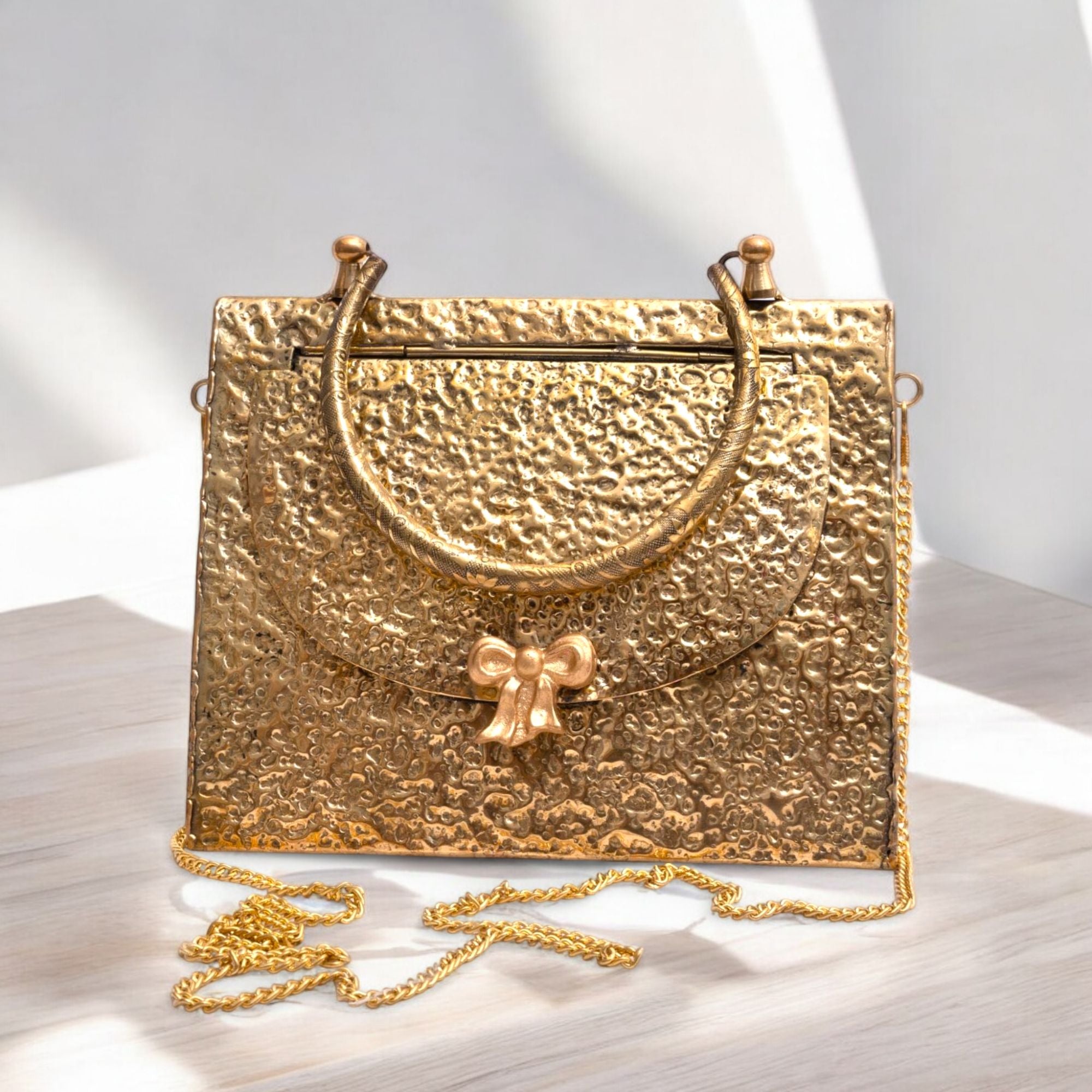 TRIANGLE HAMMERED BRASS BOW BAG IN GOLD