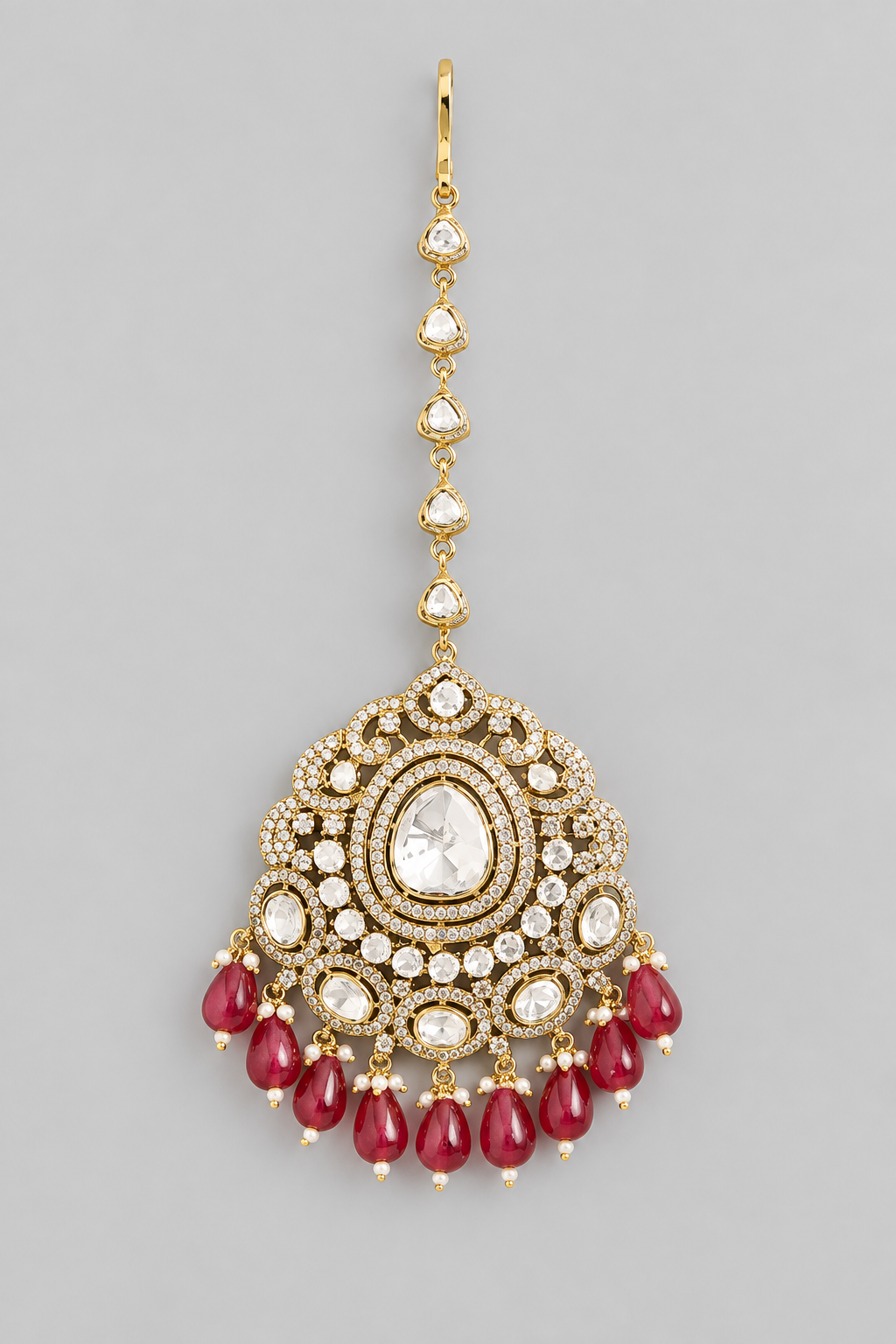 Bold and dramatic kundan polki maangtika with red pearls