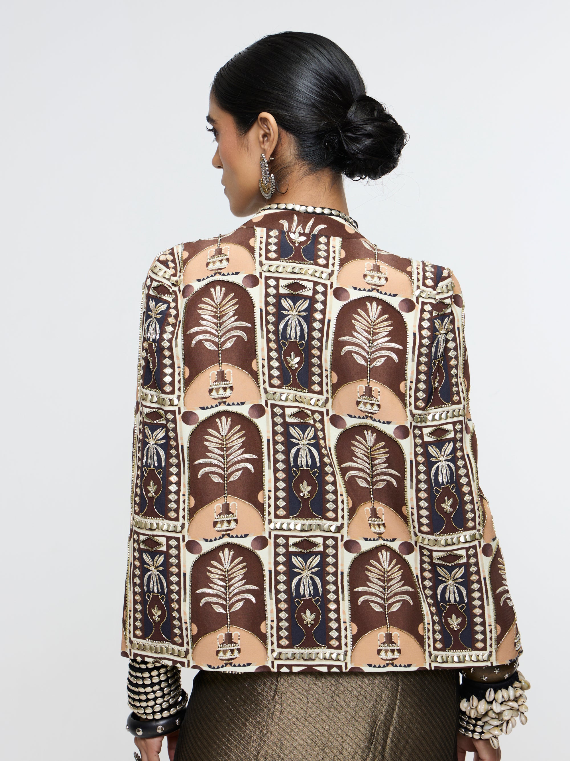 AMER JACKET PAIRED WITH EMBELLISHED BUSTIER AND HIGH-SLIT SKIRT