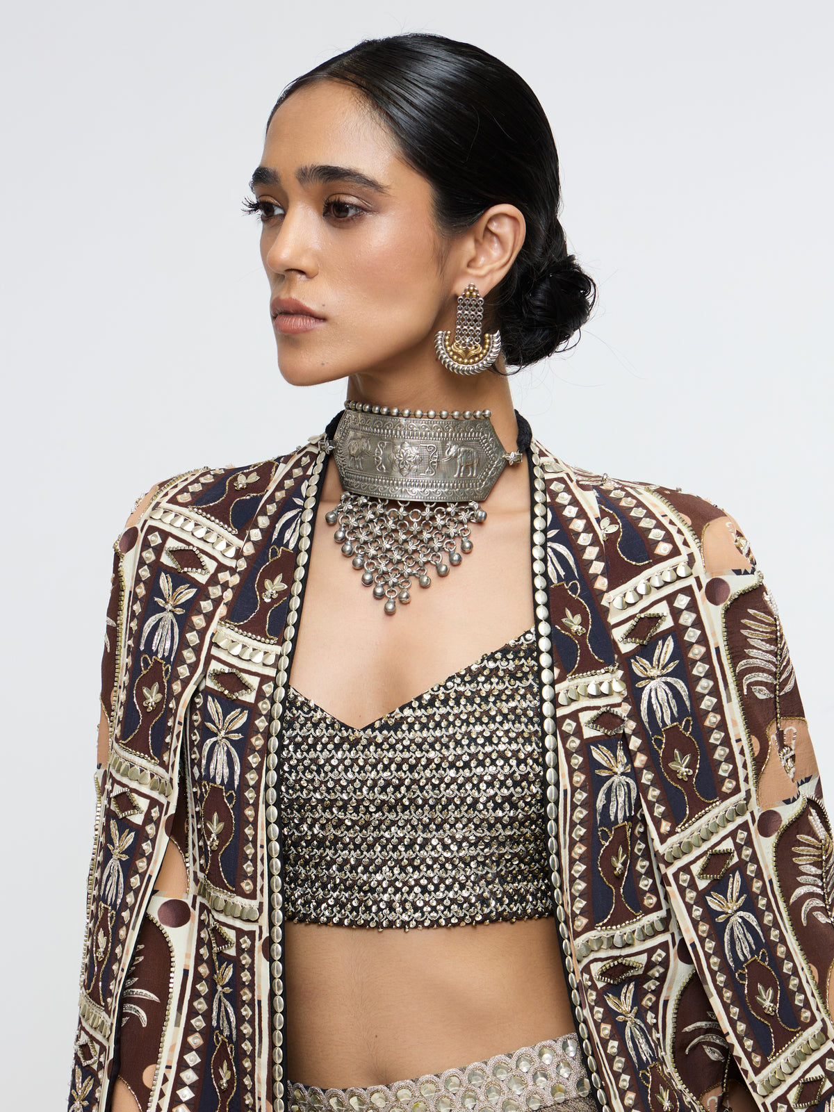 AMER JACKET PAIRED WITH EMBELLISHED BUSTIER AND HIGH-SLIT SKIRT