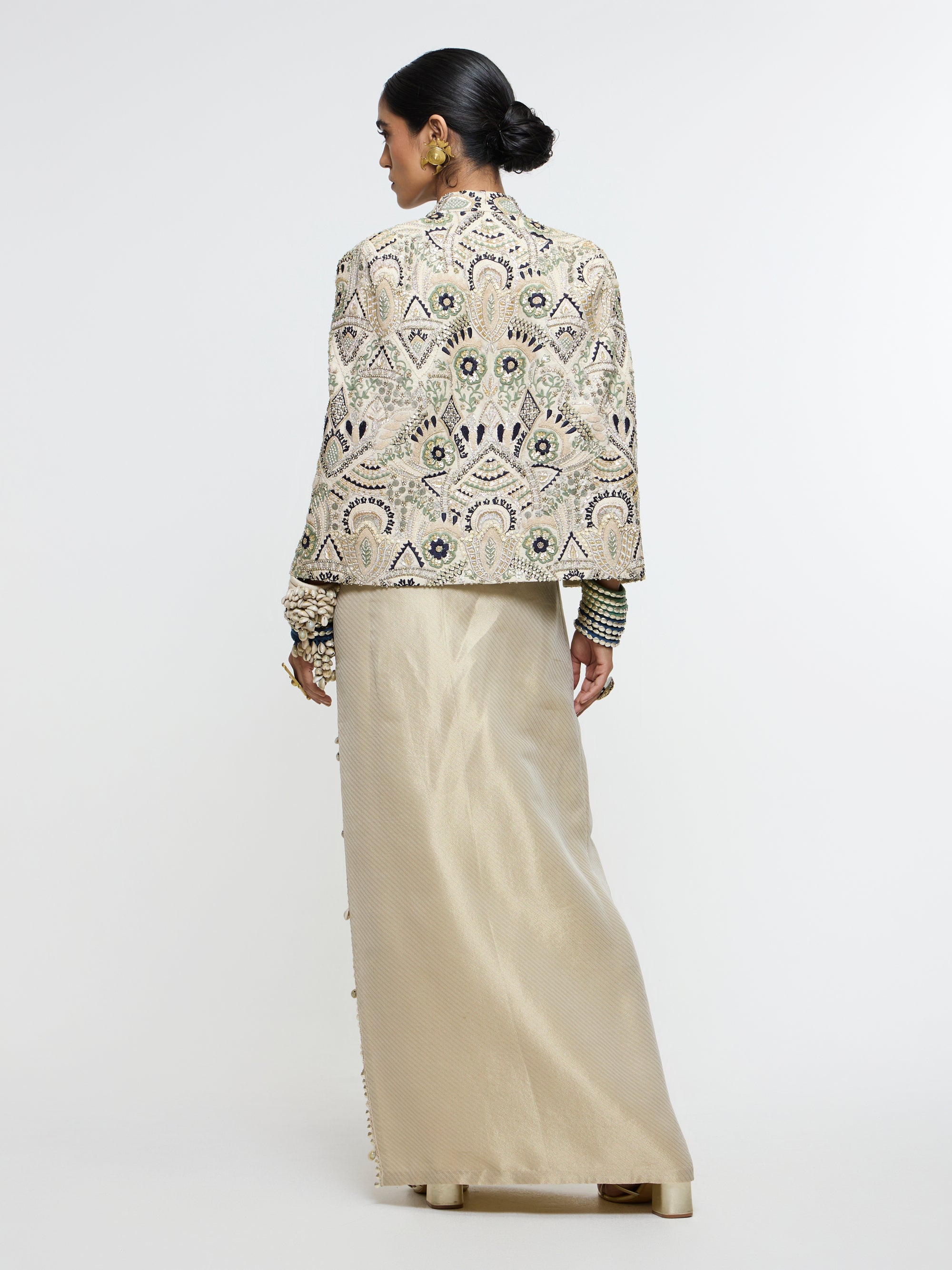 INAYAT EMBELLISHED CAPE JACKET PAIRED WITH METALLIC SCALLOP BUSTIER AND IVORY SLIT SKIRT
