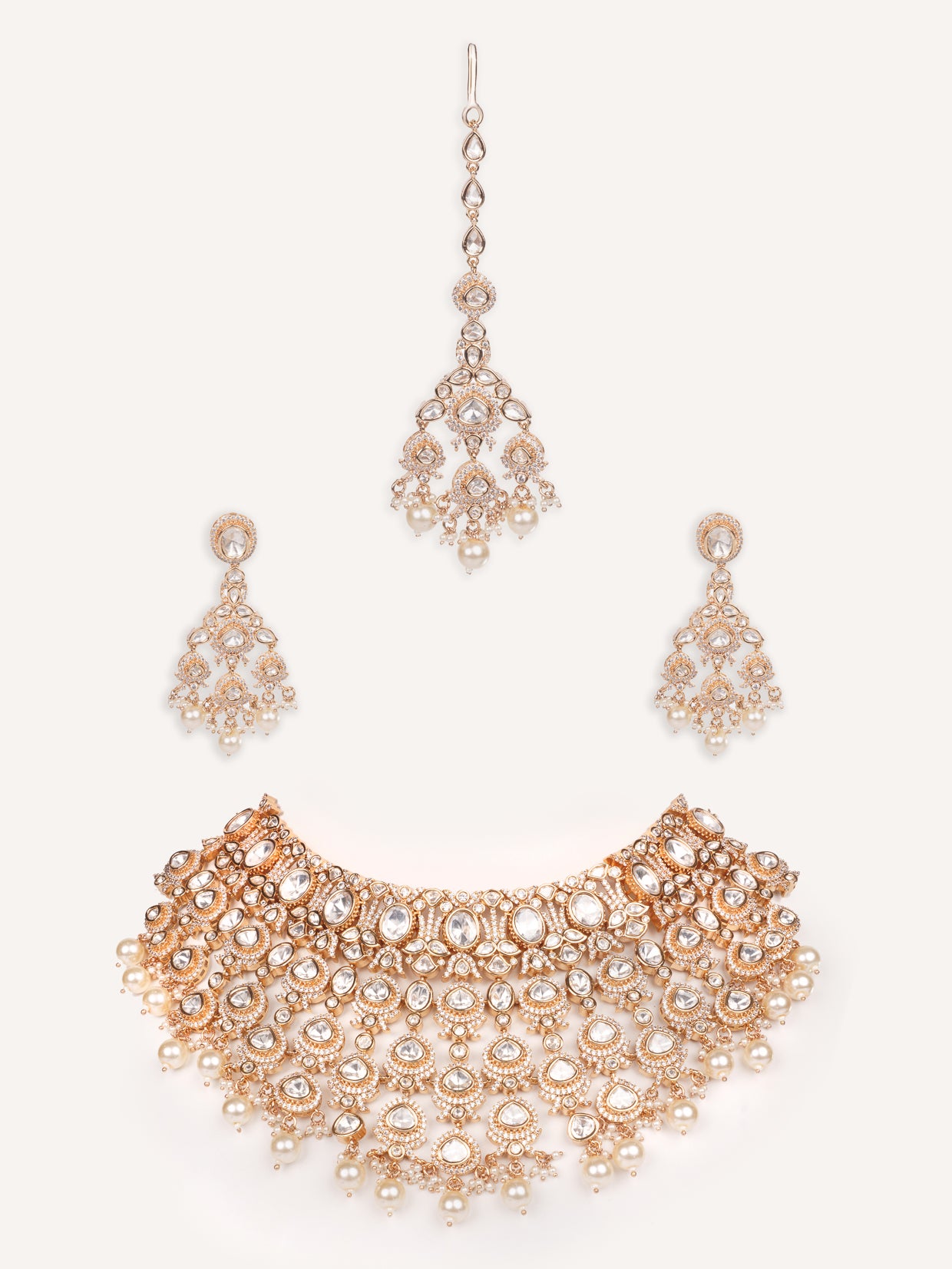 Traditional yet dramatic kundan necklace set with matching earrings and maangtika