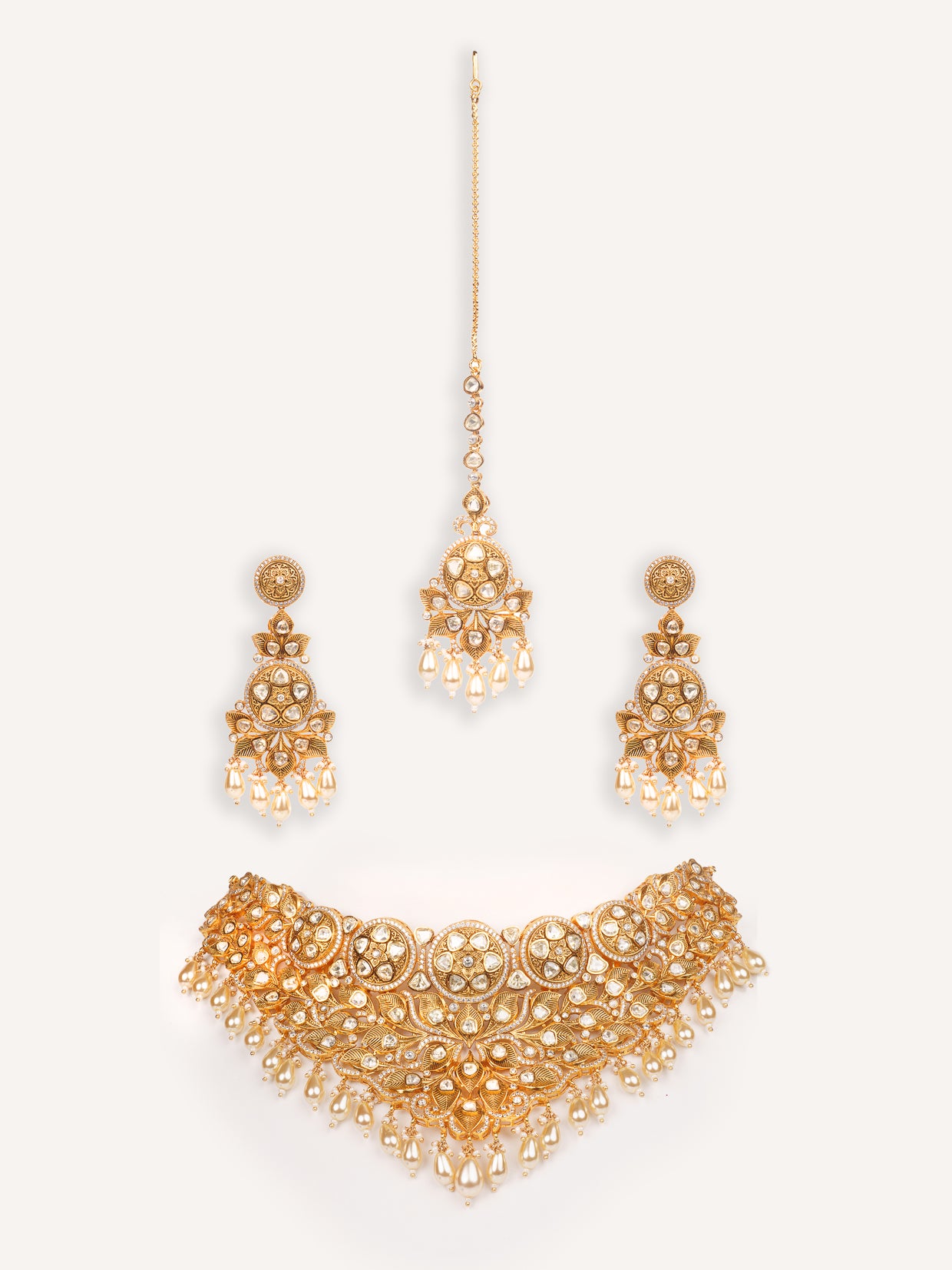 Traditional yet dramatic kundan necklace set with matching earrings and maangtika