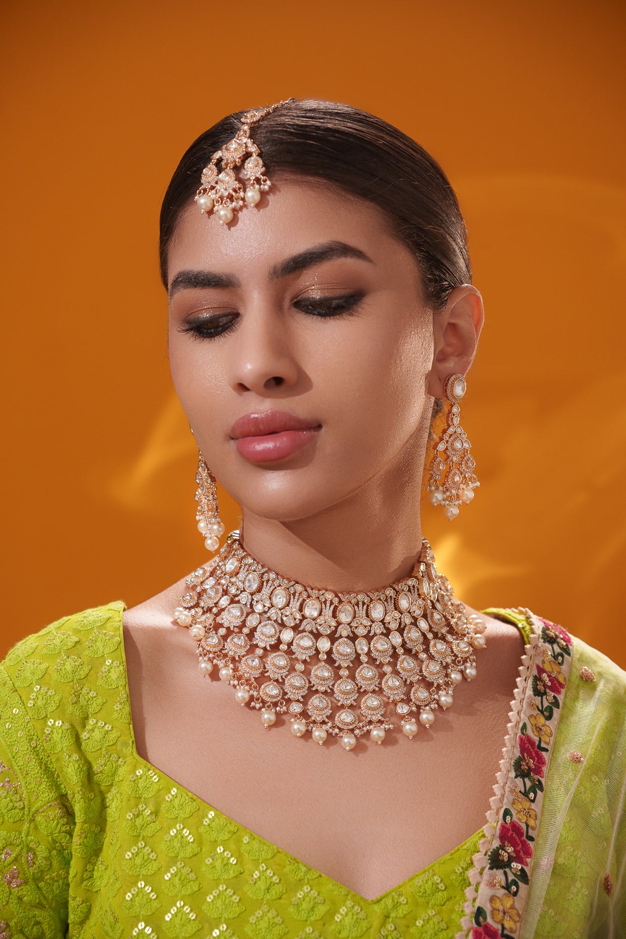 Traditional yet dramatic kundan necklace set with matching earrings and maangtika
