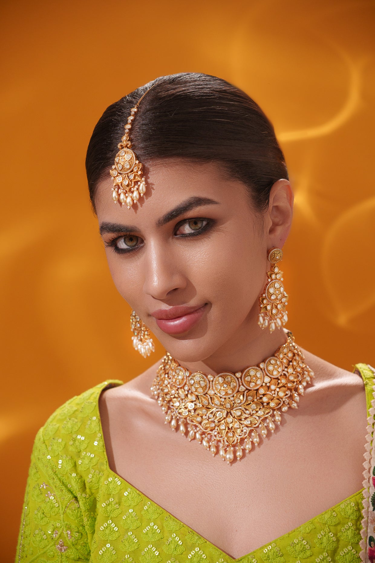 Traditional yet dramatic kundan necklace set with matching earrings and maangtika