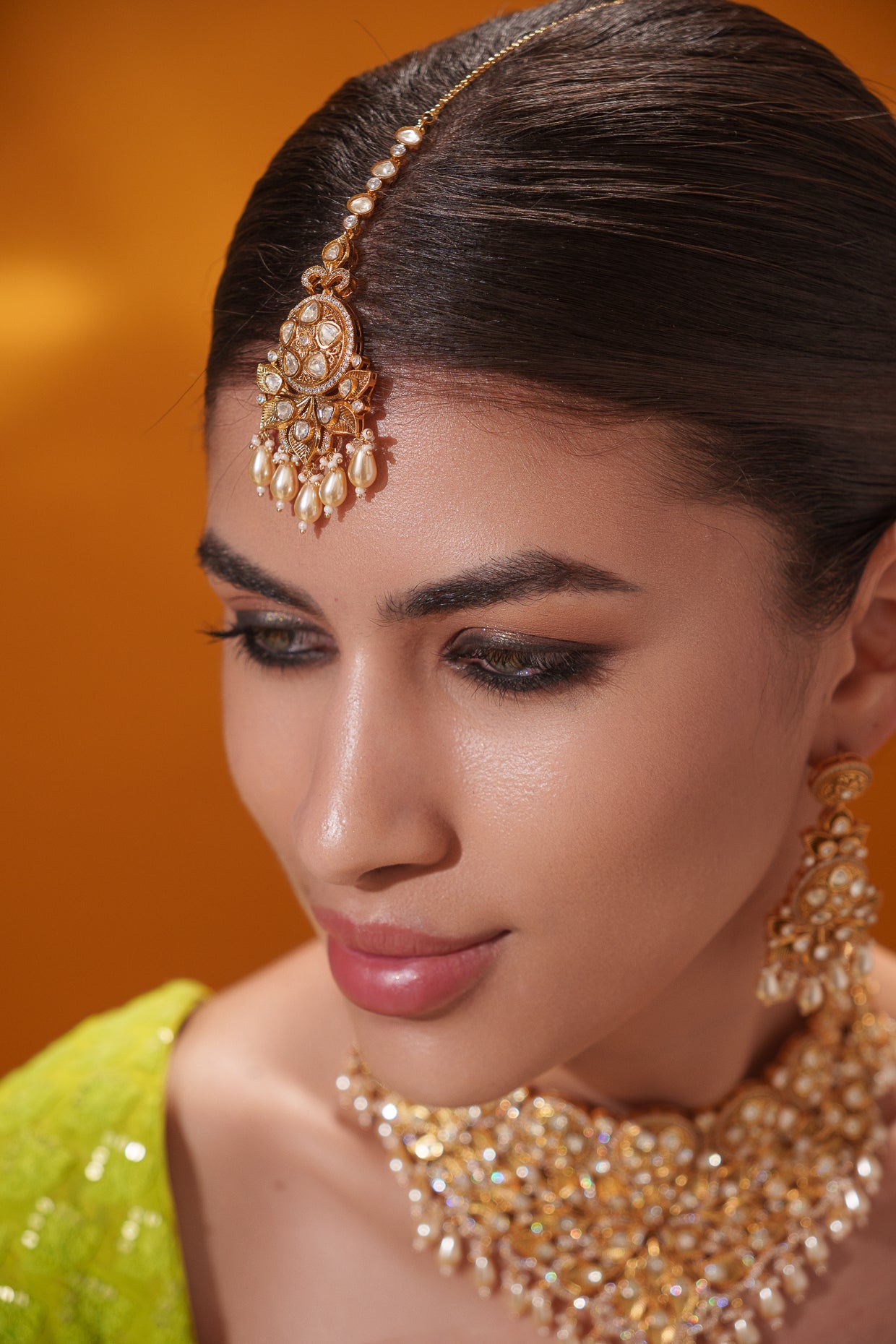 Traditional yet dramatic kundan necklace set with matching earrings and maangtika