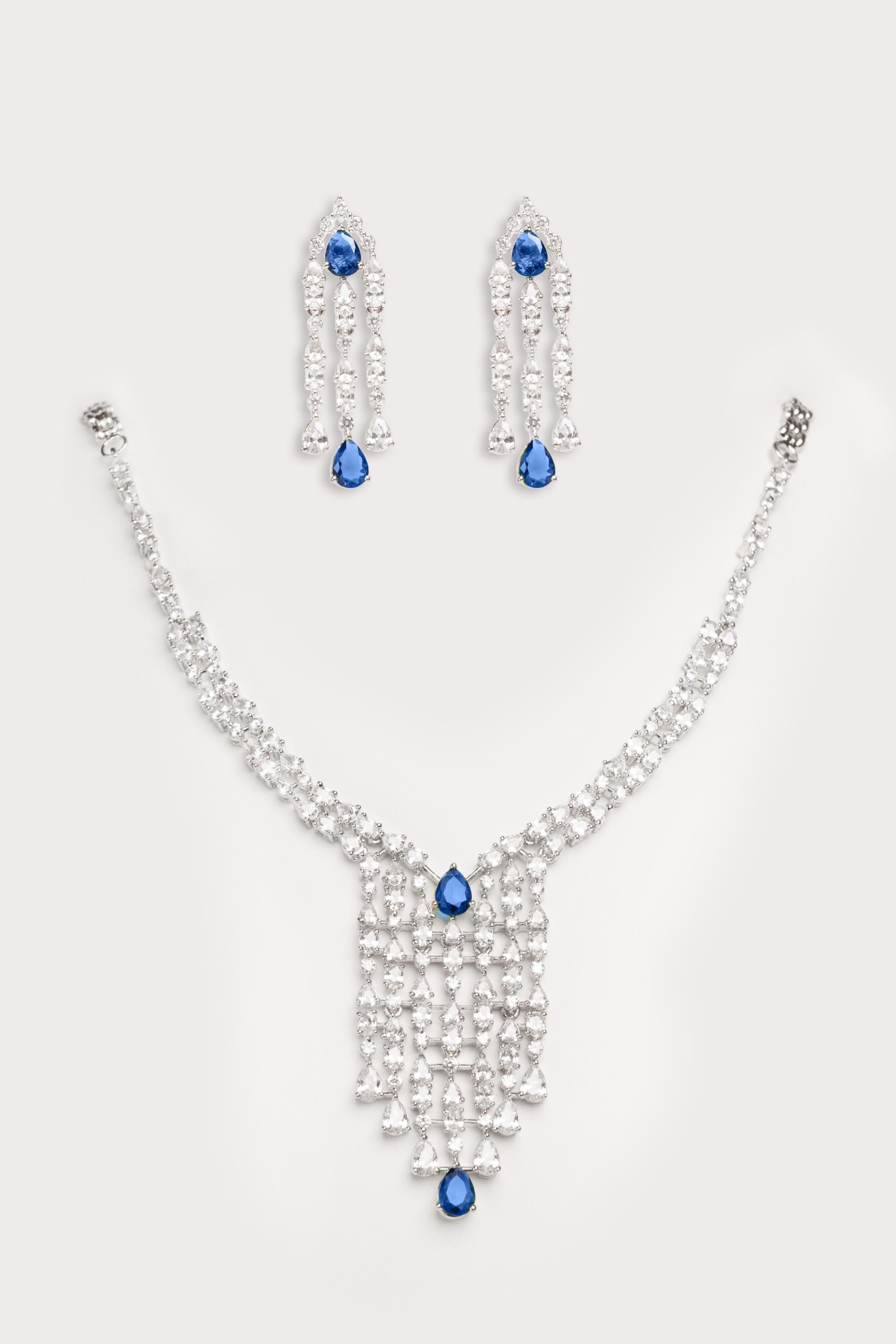 Elegant and sleek diamond pendant set with sapphire stone and earrings