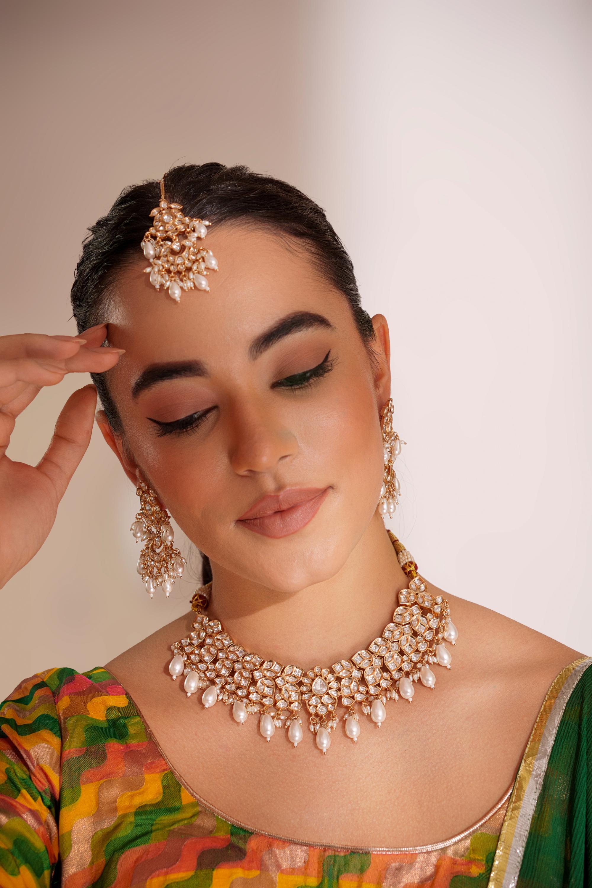 Elegant and classy kundan necklace set with earrings and maangtikka studded with pearls