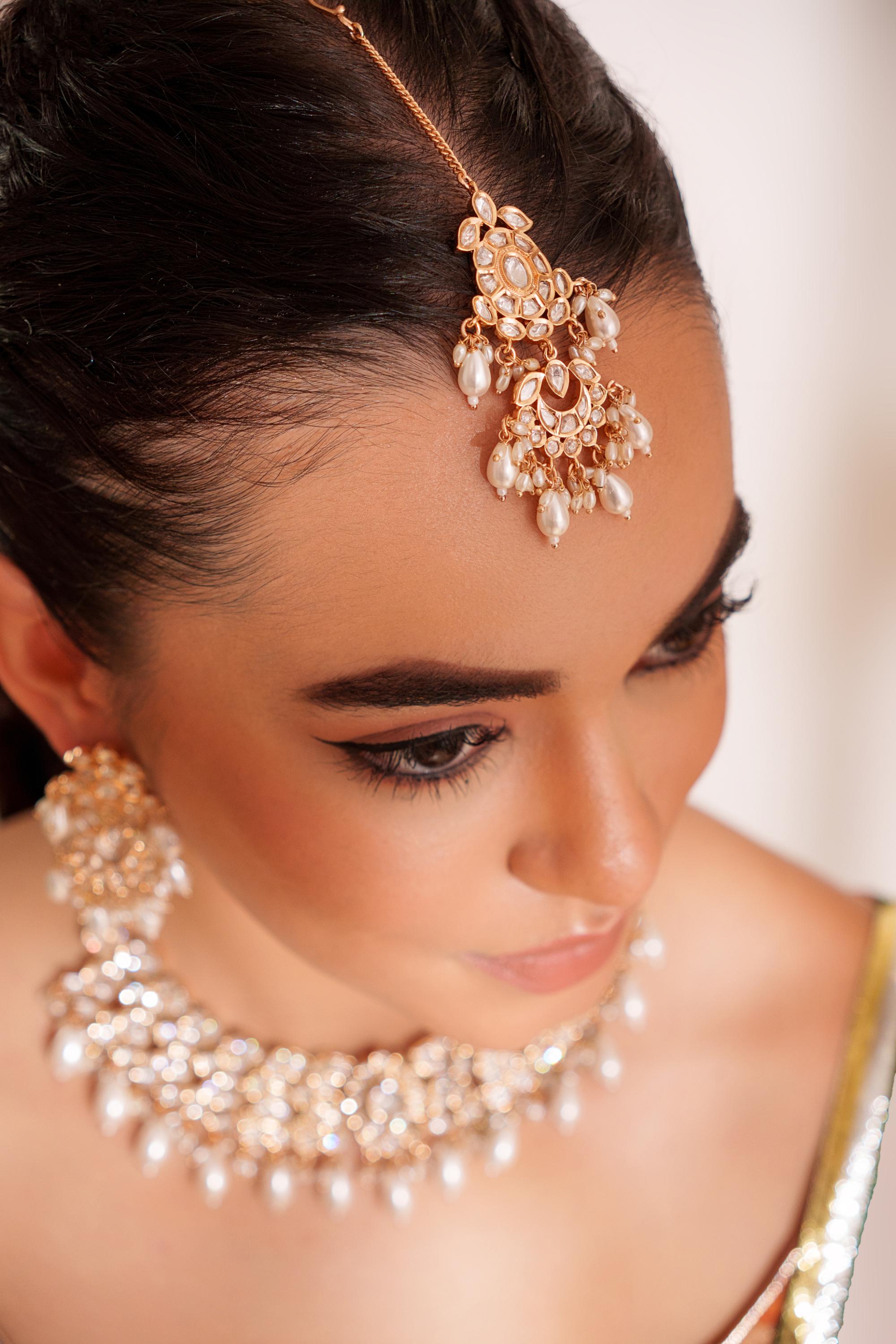 Elegant and classy kundan necklace set with earrings and maangtikka studded with pearls