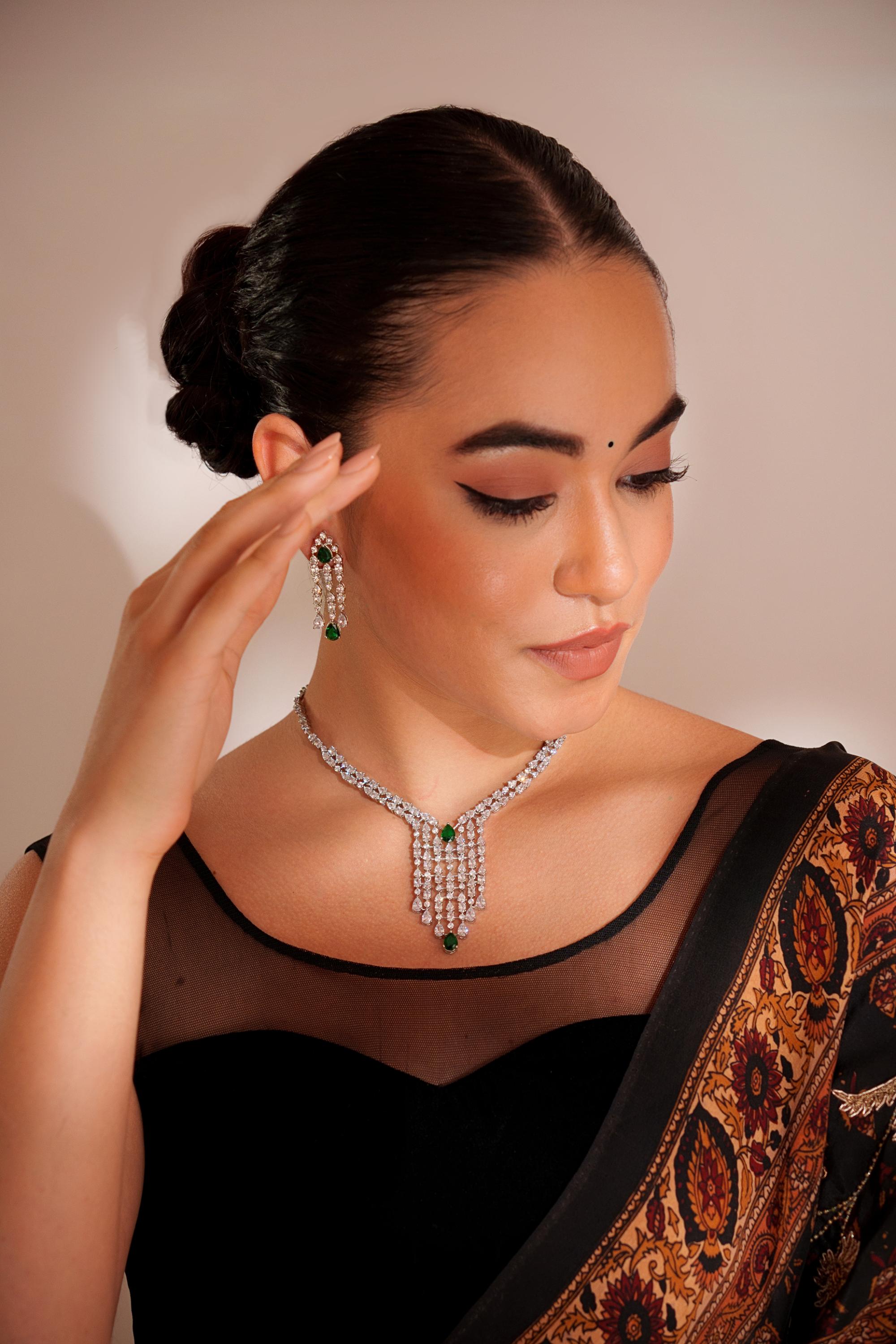 Elegant and sleek diamond pendant set with emerald stone and earrings