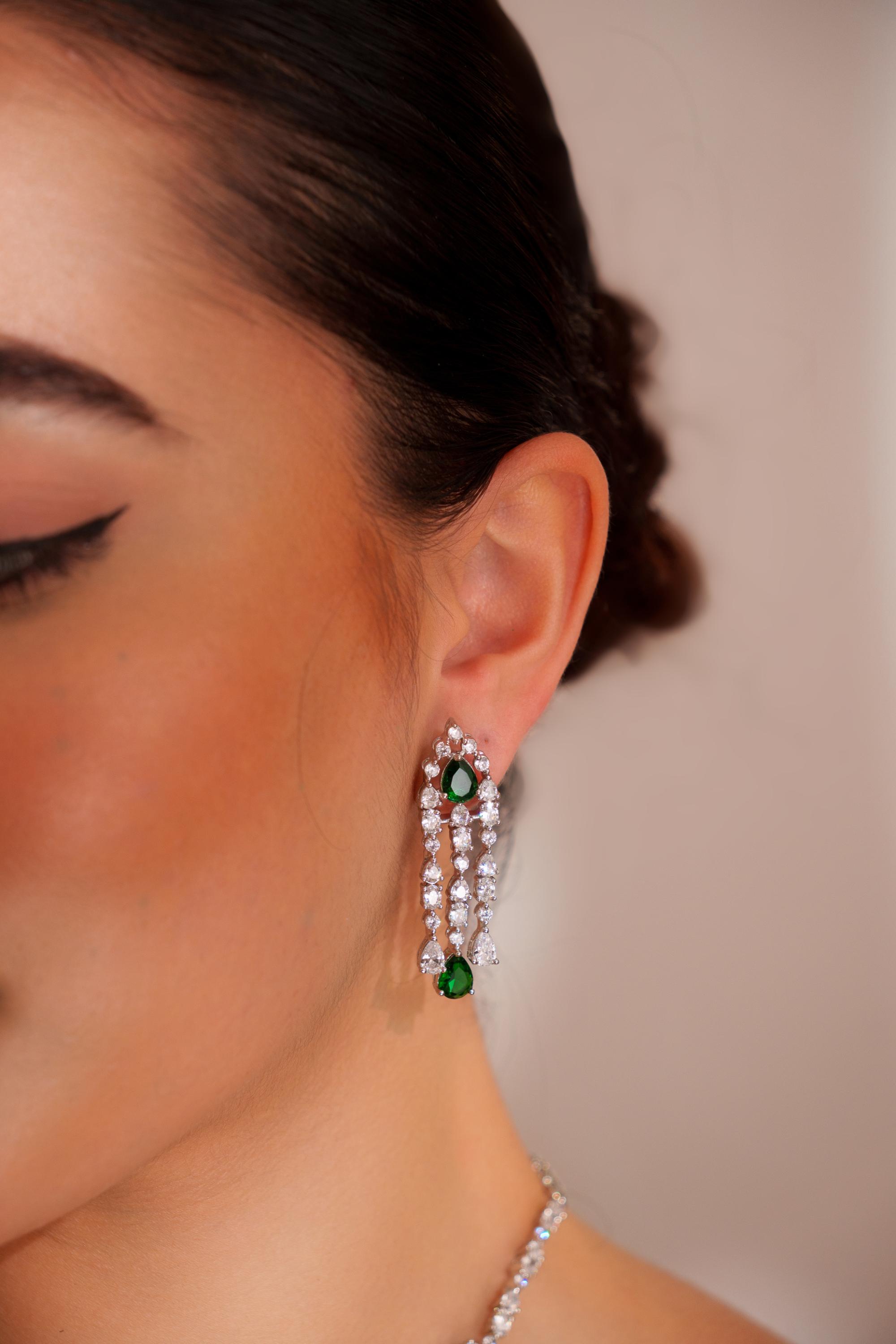 Elegant and sleek diamond pendant set with emerald stone and earrings