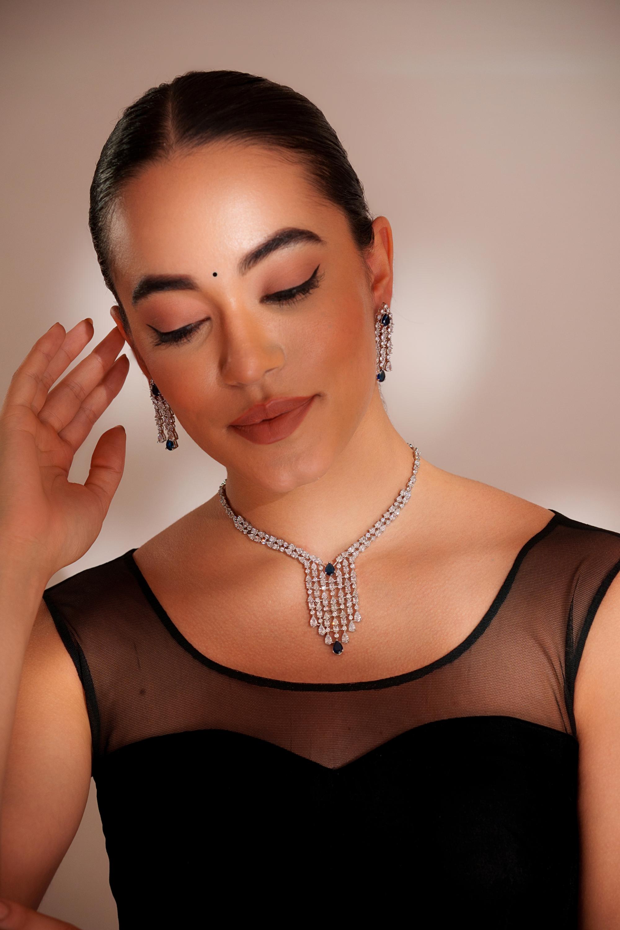 Elegant and sleek diamond pendant set with sapphire stone and earrings