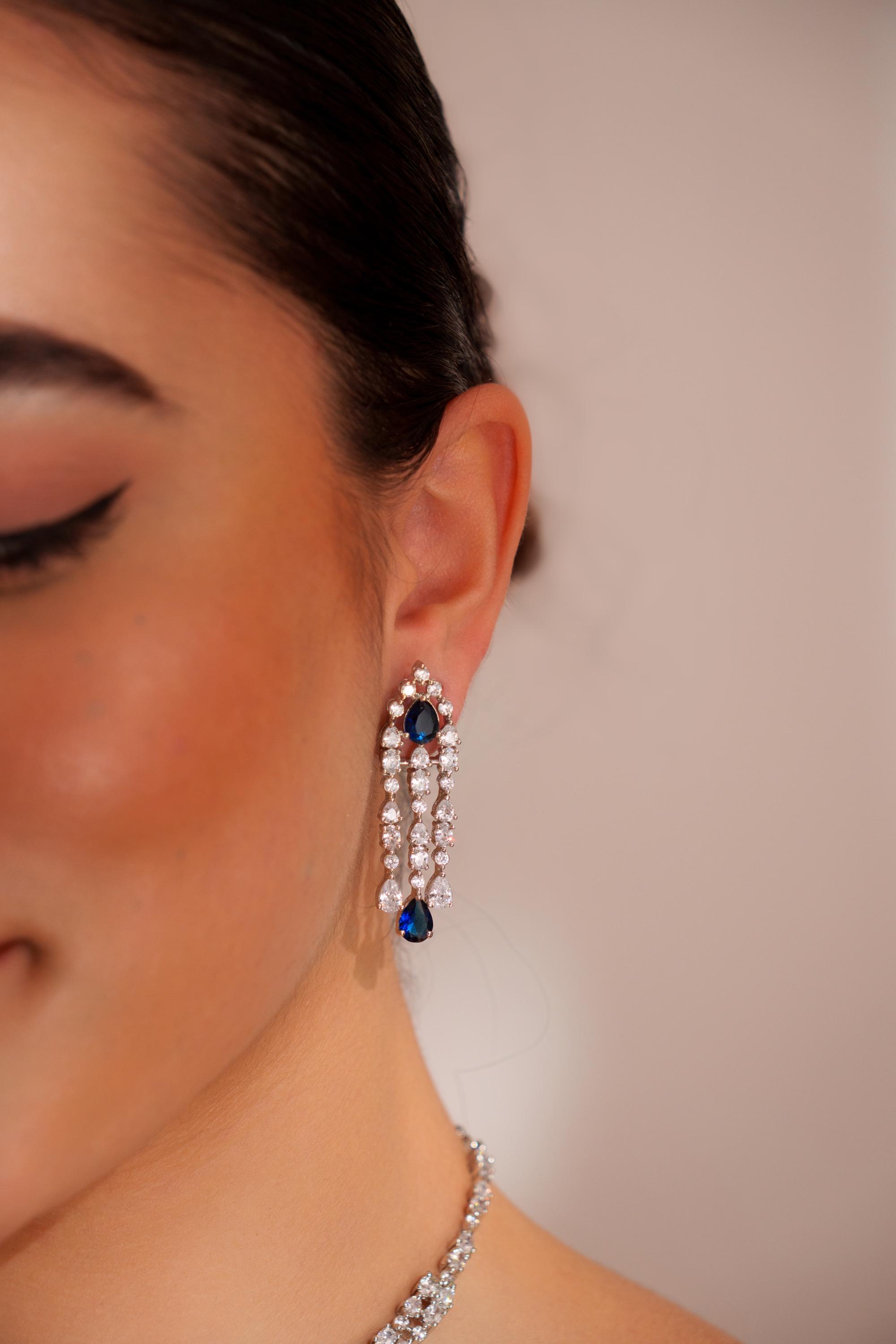 Elegant and sleek diamond pendant set with sapphire stone and earrings