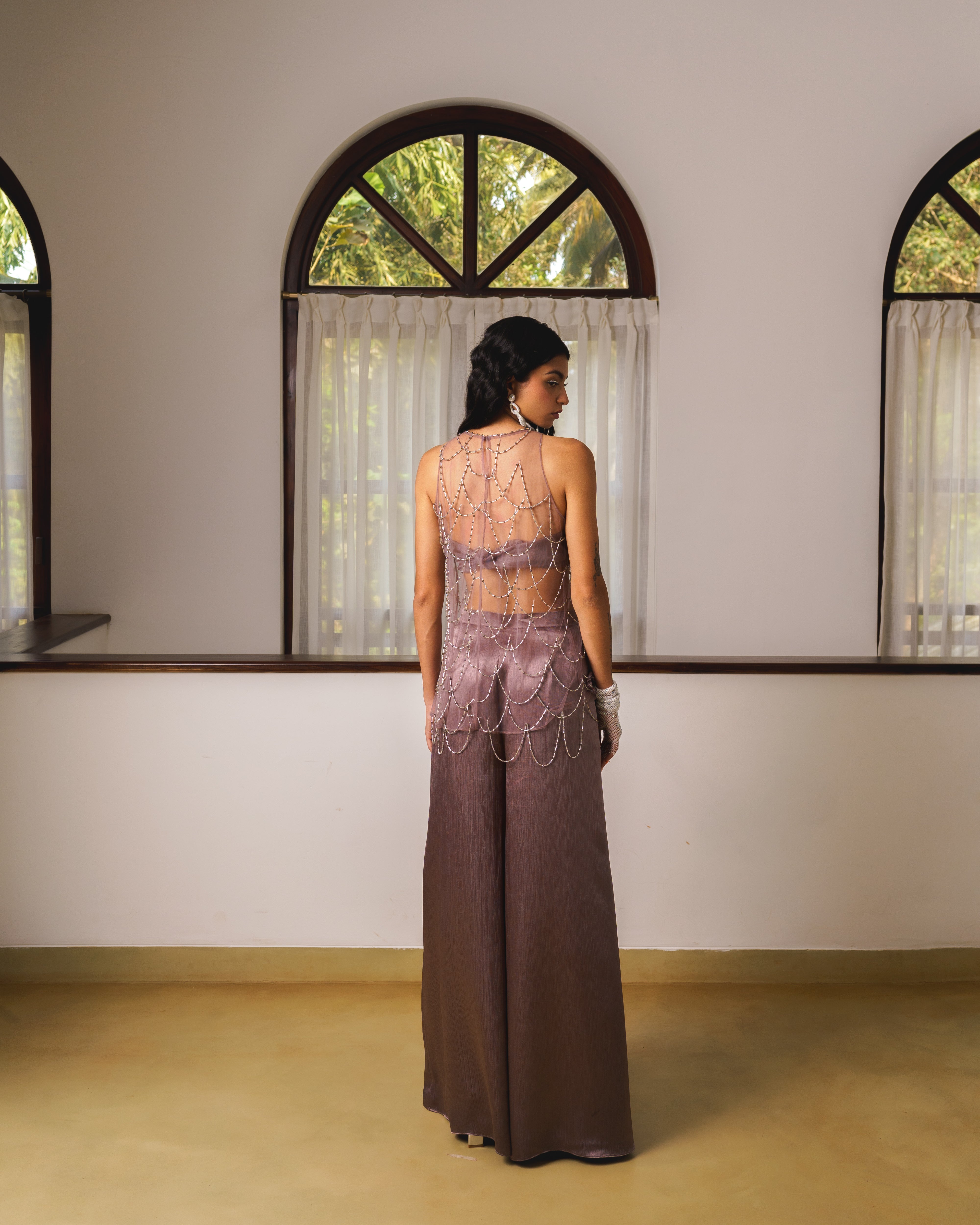 Short kurta top with hand embroidered tassels, bustier and flare pants