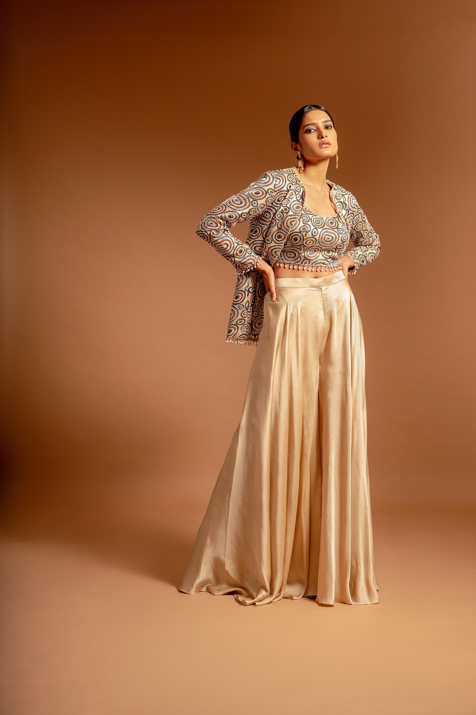 Beige fully handcrafted blouse and ajrakh jacket with flare pants