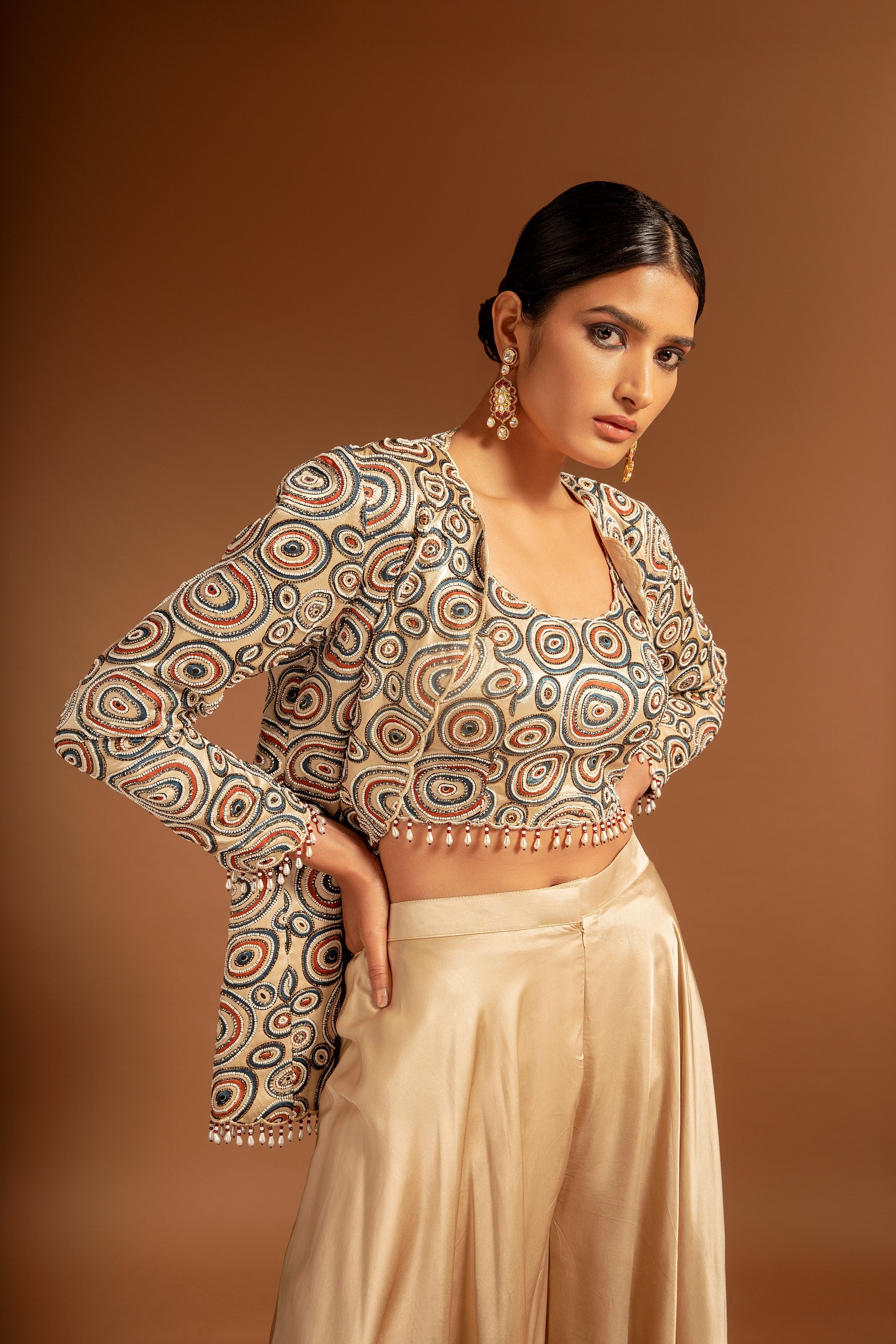Beige fully handcrafted blouse and ajrakh jacket with flare pants
