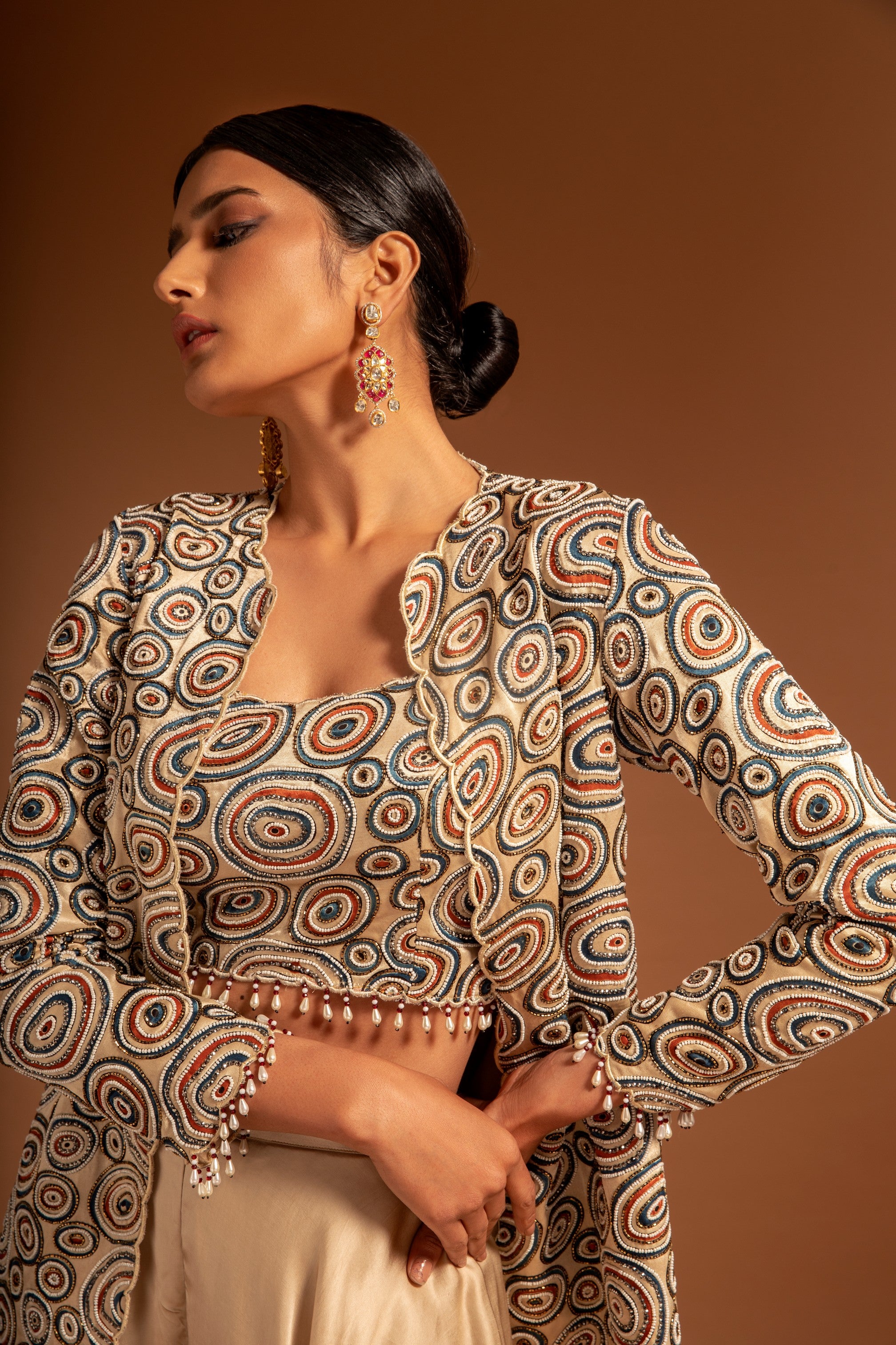 Beige fully handcrafted blouse and ajrakh jacket with flare pants