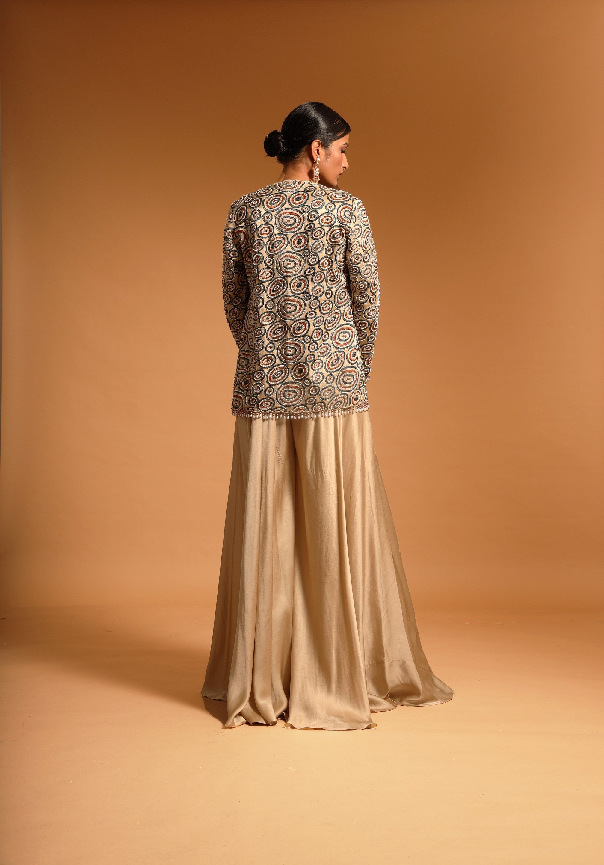 Beige fully handcrafted blouse and ajrakh jacket with flare pants