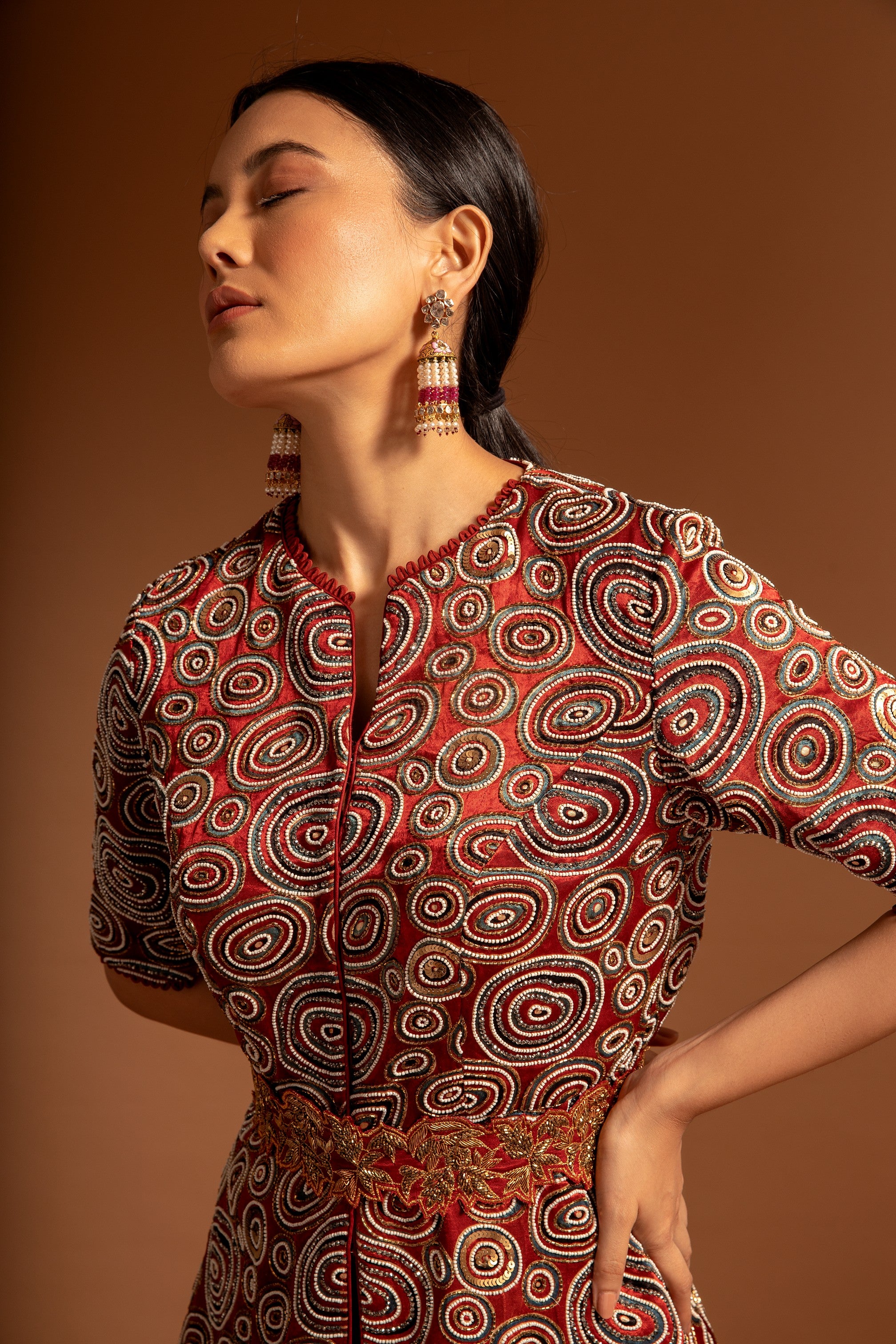 Red embroidered ajarkh peplum top with flare pants and embroidered waistbelt