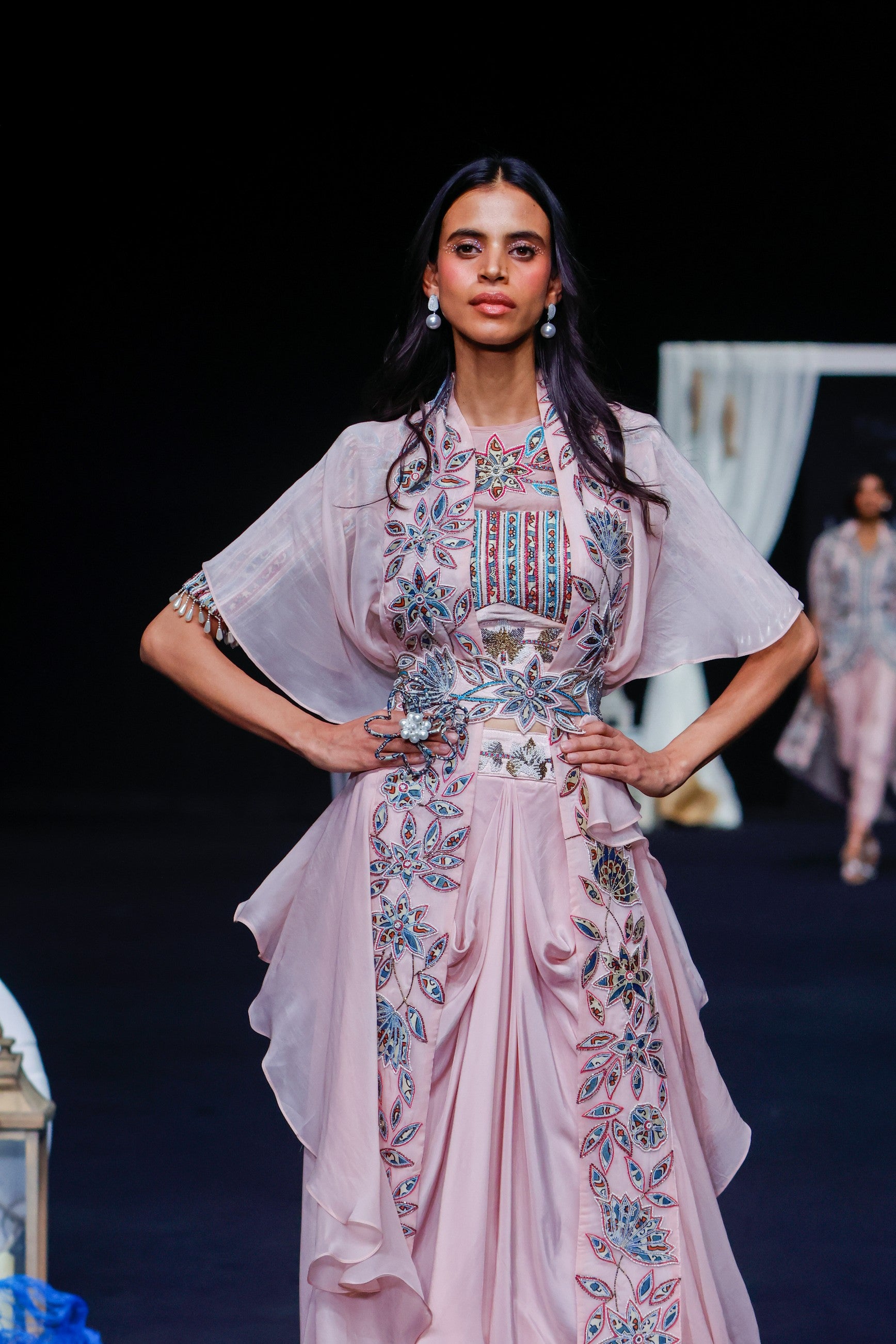 Peachy pink Ajrakh embroidered blouse paired up with Dhoti and ruffled dupatta