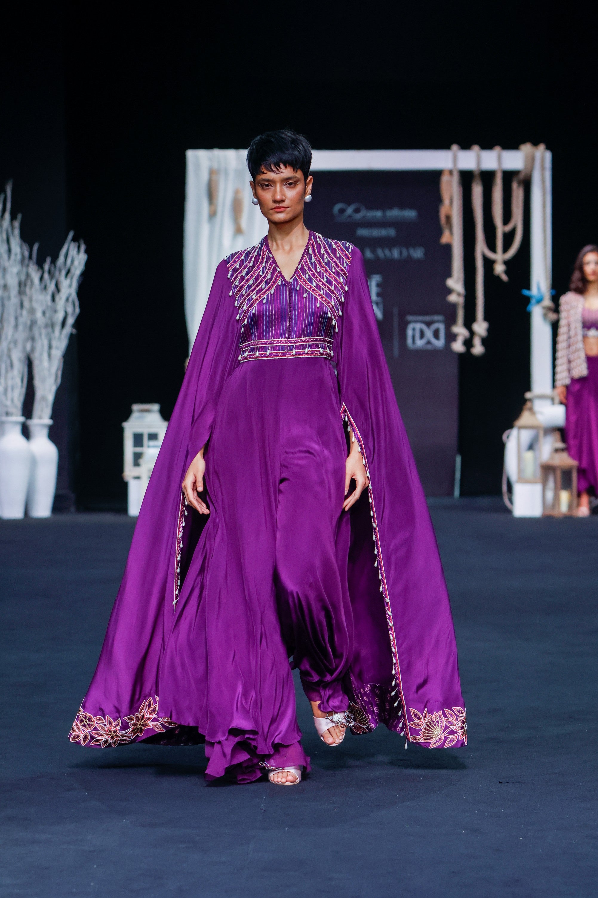 Purple heavily embellished jumpsuit with embroidered cape sleeves
