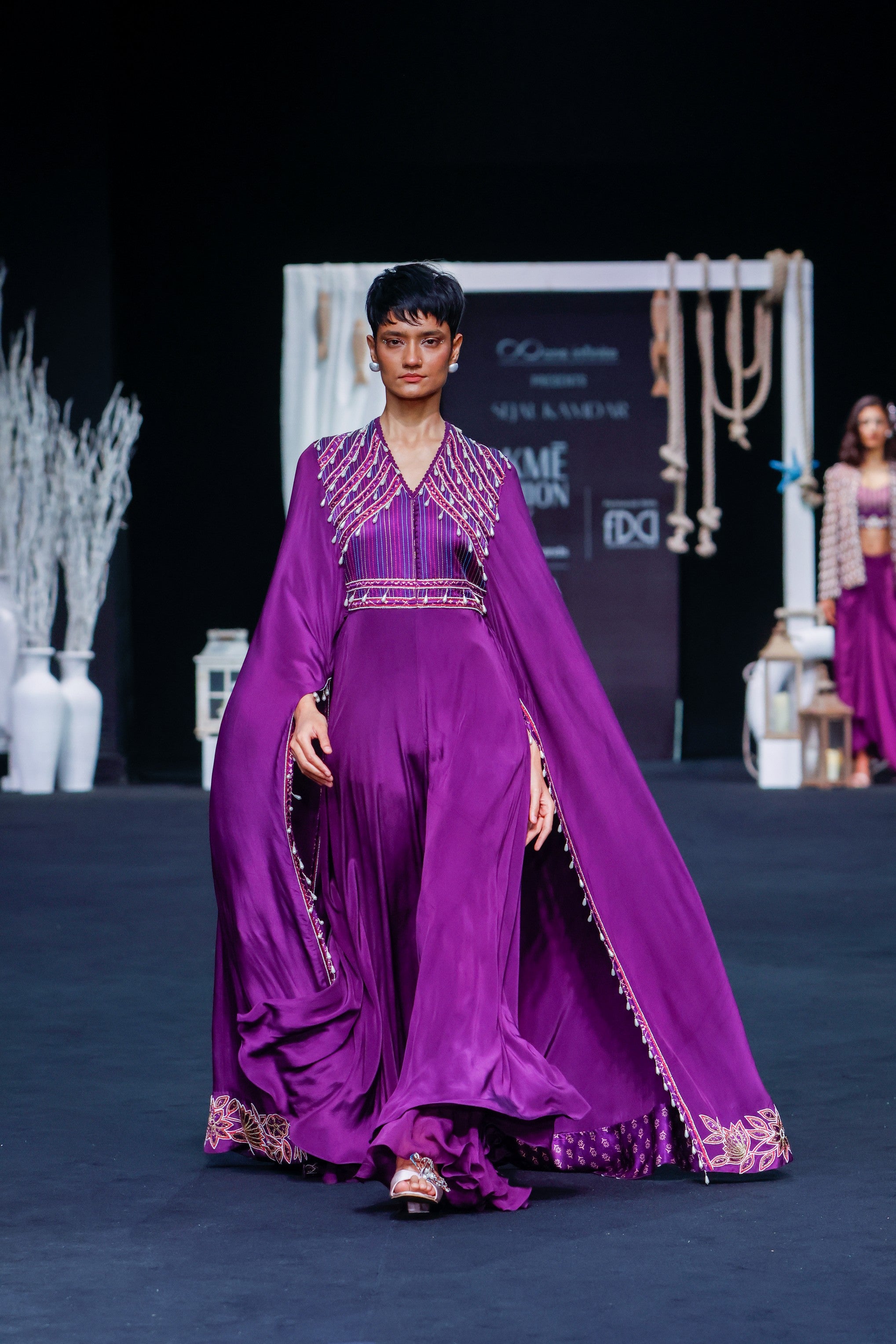 Purple heavily embellished jumpsuit with embroidered cape sleeves