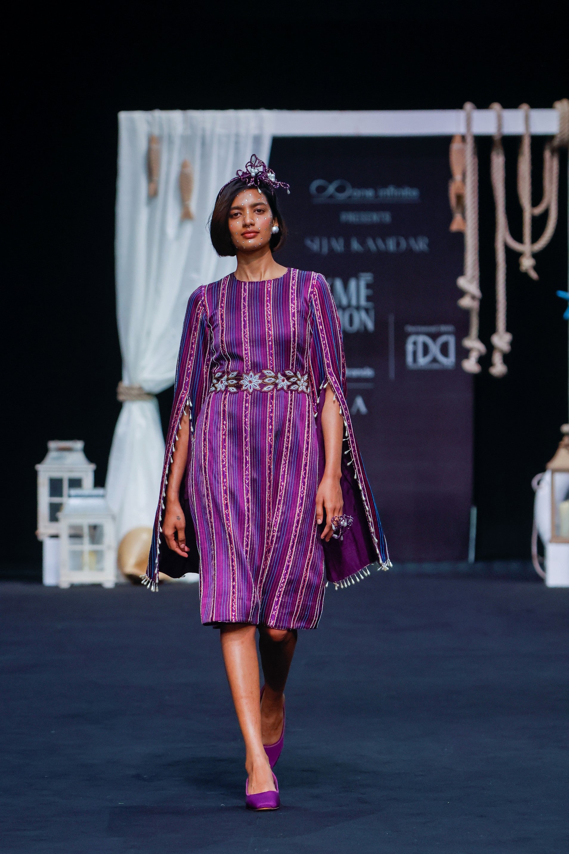 Dark purple heavily stripworked dress with cape sleeves