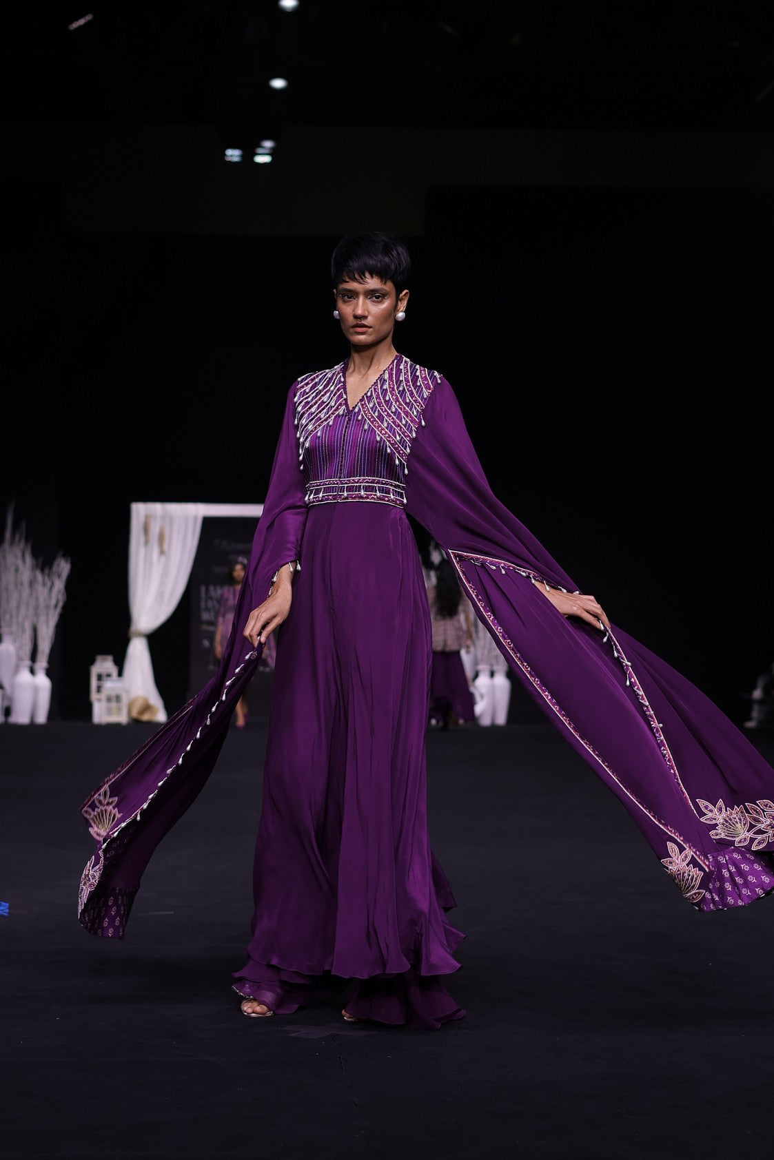 Purple heavily embellished jumpsuit with embroidered cape sleeves
