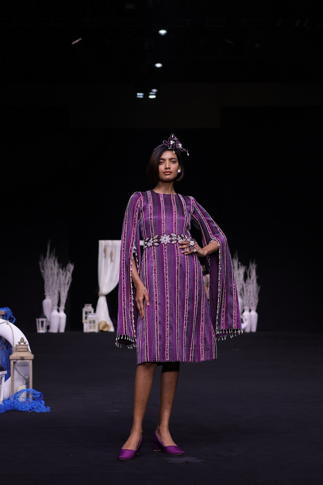 Dark purple heavily stripworked dress with cape sleeves