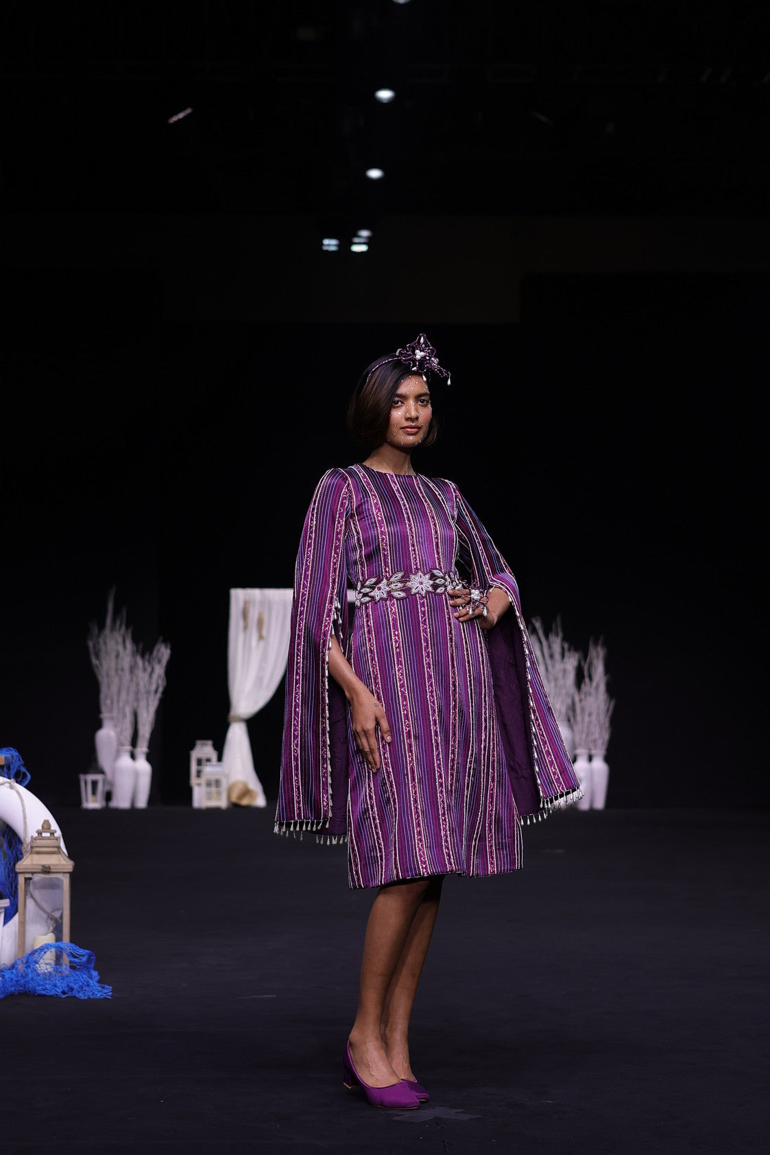 Dark purple heavily stripworked dress with cape sleeves