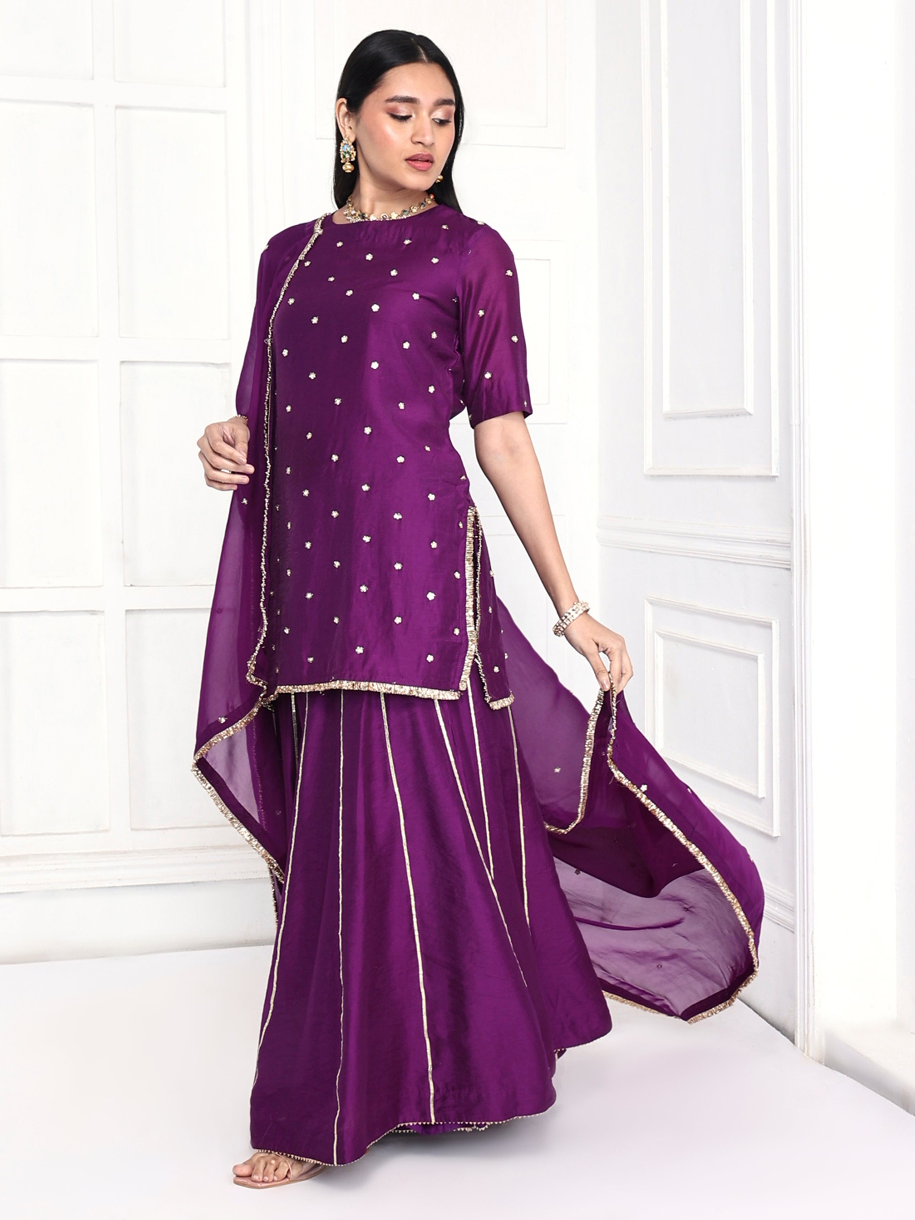 Short kurta is paired with kali palazzo and a dupatta