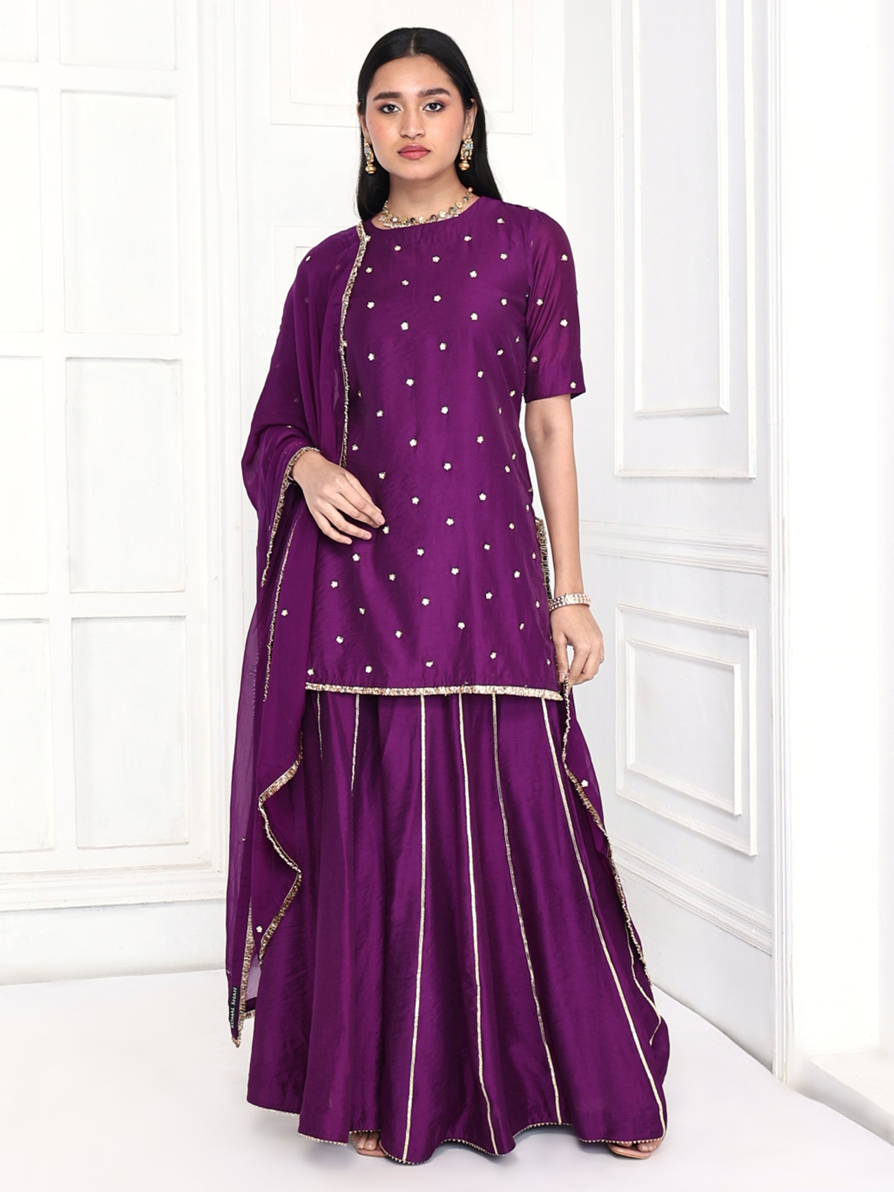 Short kurta is paired with kali palazzo and a dupatta