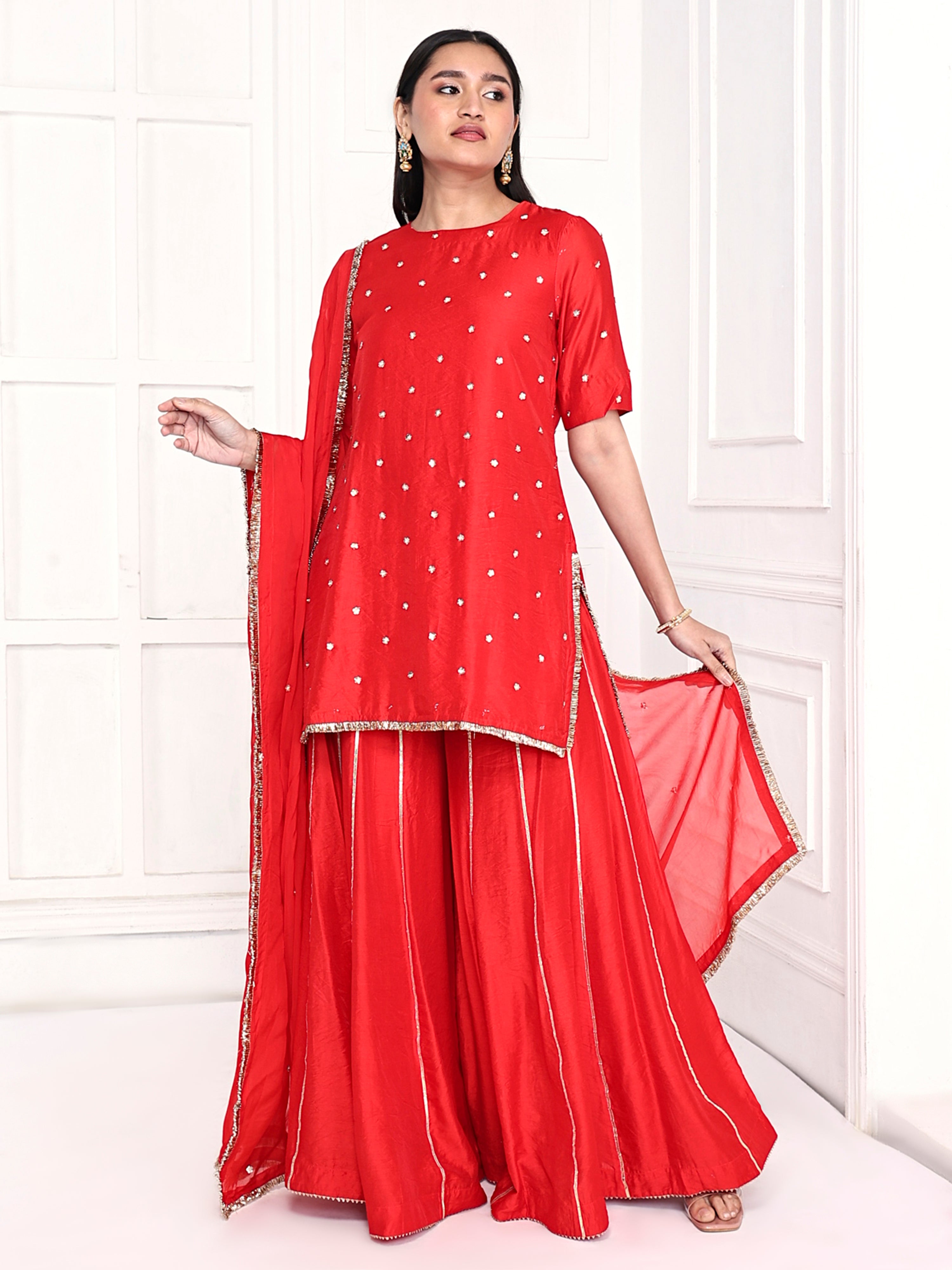 Short kurta is paired with kali palazzo and a dupatta