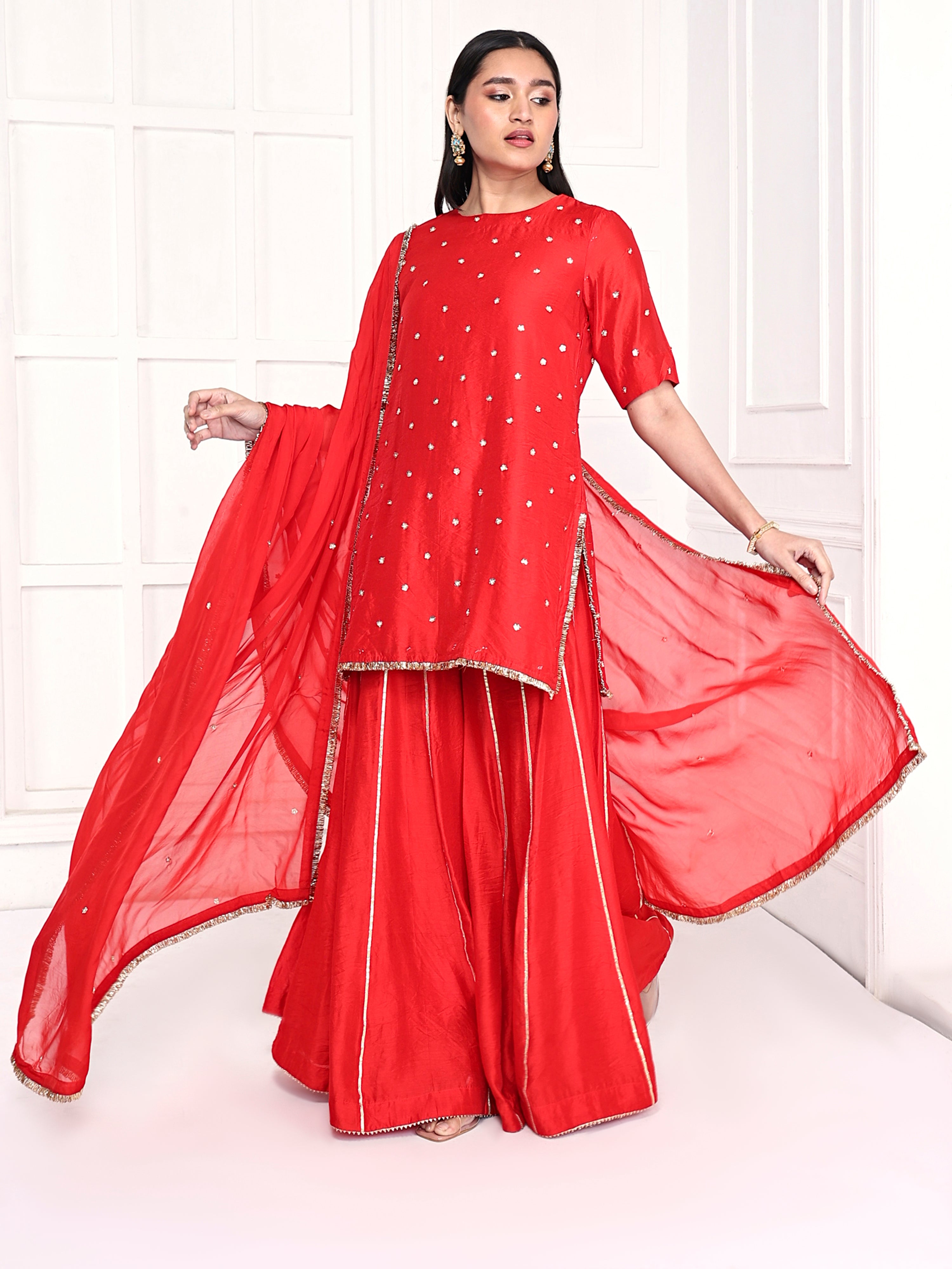 Short kurta is paired with kali palazzo and a dupatta