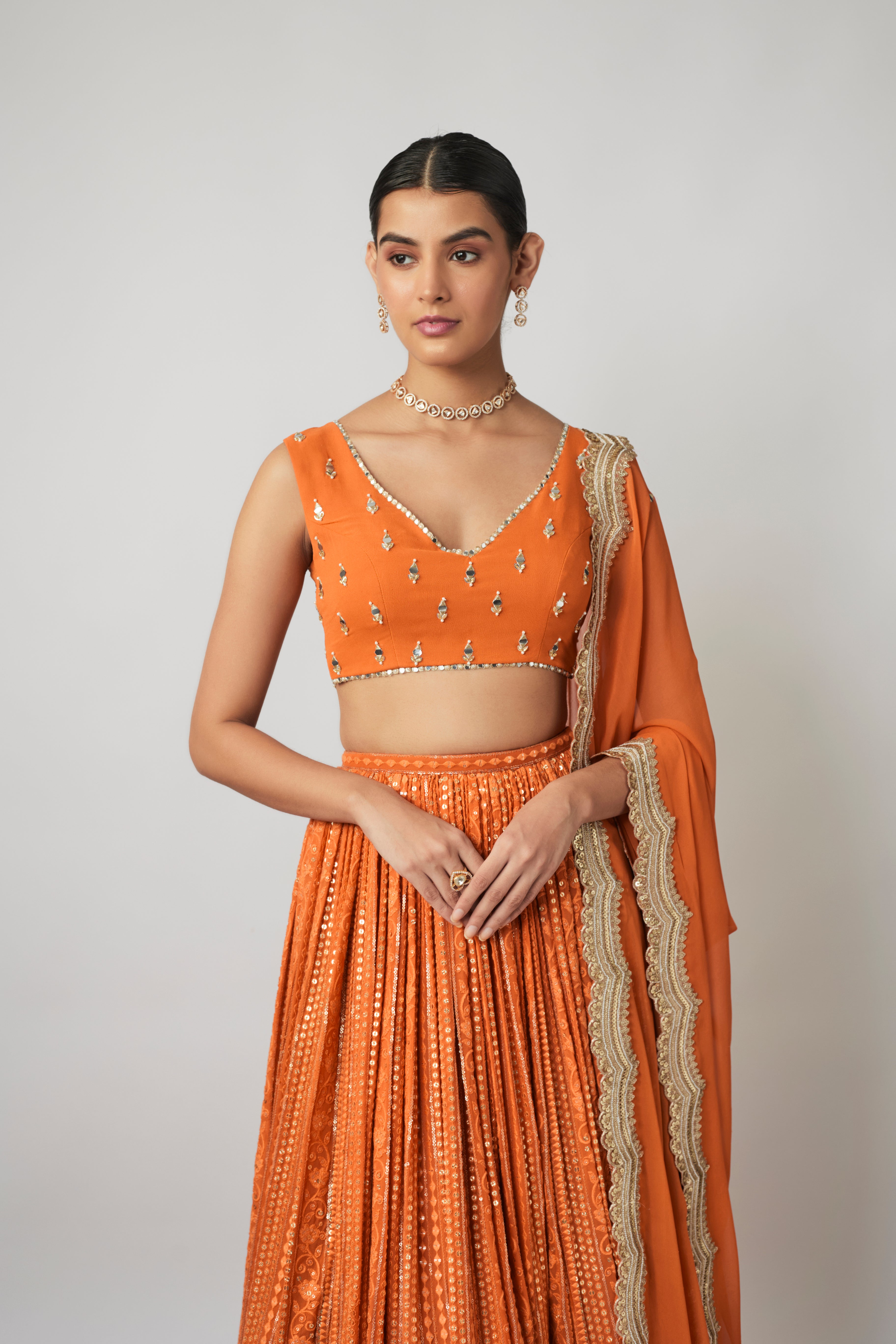 Saffron orange sequin and thread embroidered georgette lehenga set