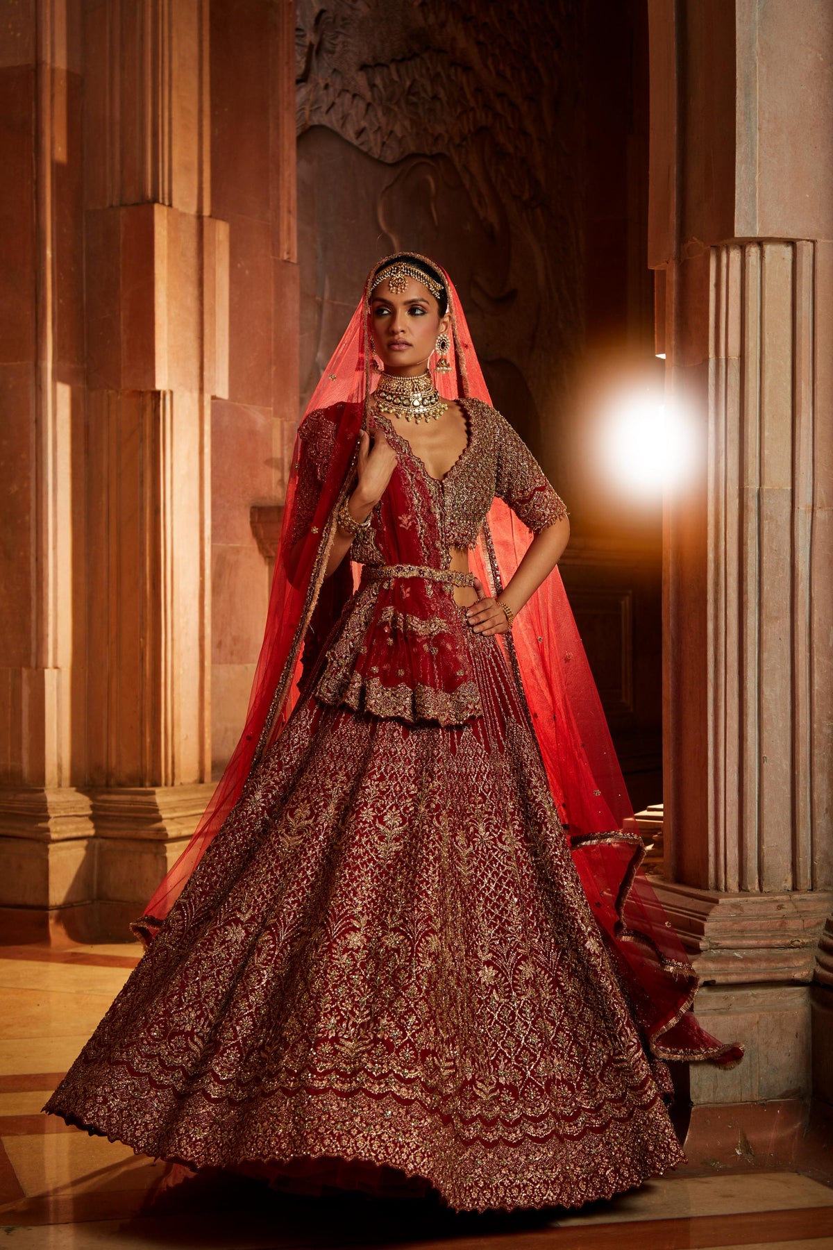 Jannat Khan In Blood Red Raw Silk Lehenga Choli and Belt with Tulle Dupatta with an Optional Lighter Second Dupatta