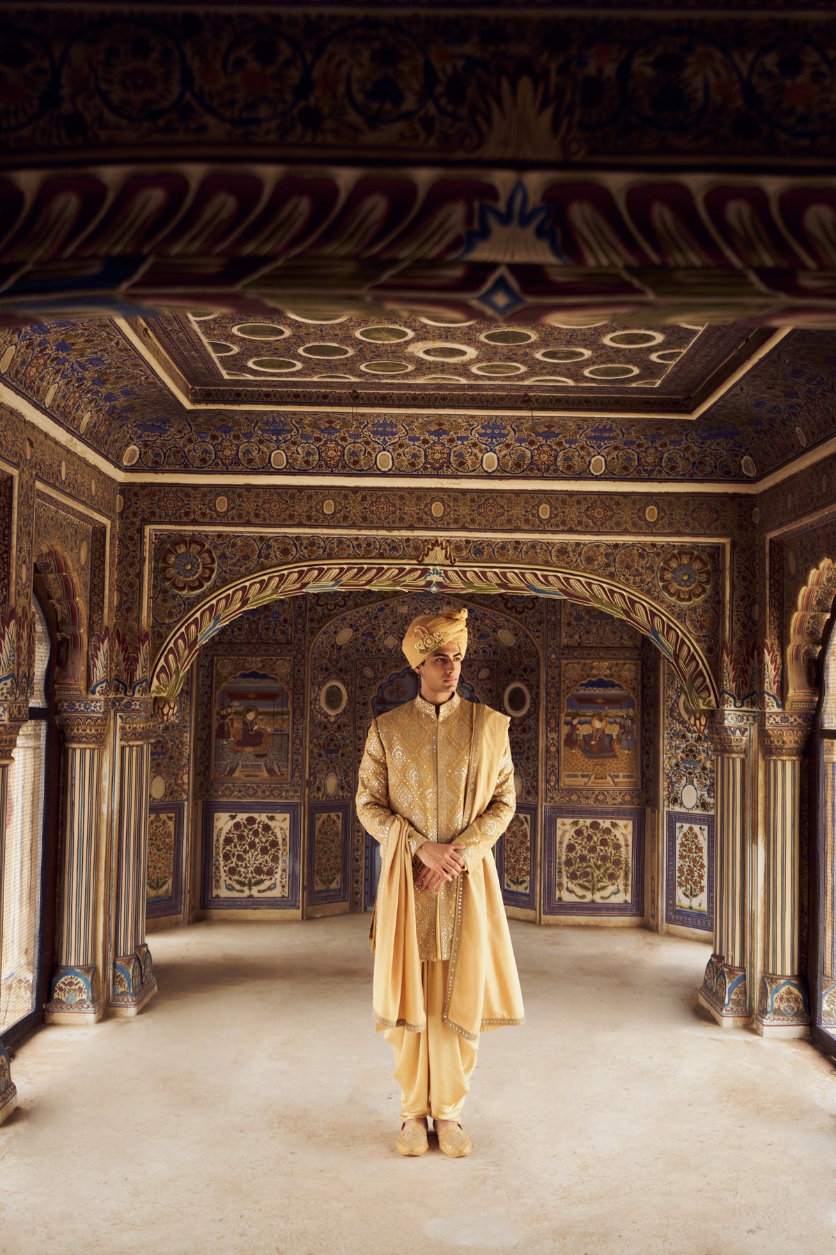 GOLD RAW SILK SHORT SHERWANI WITH SATIN KURTA AND DHOTI WITH OPTIONAL WORKED STOLE AND JUTIS