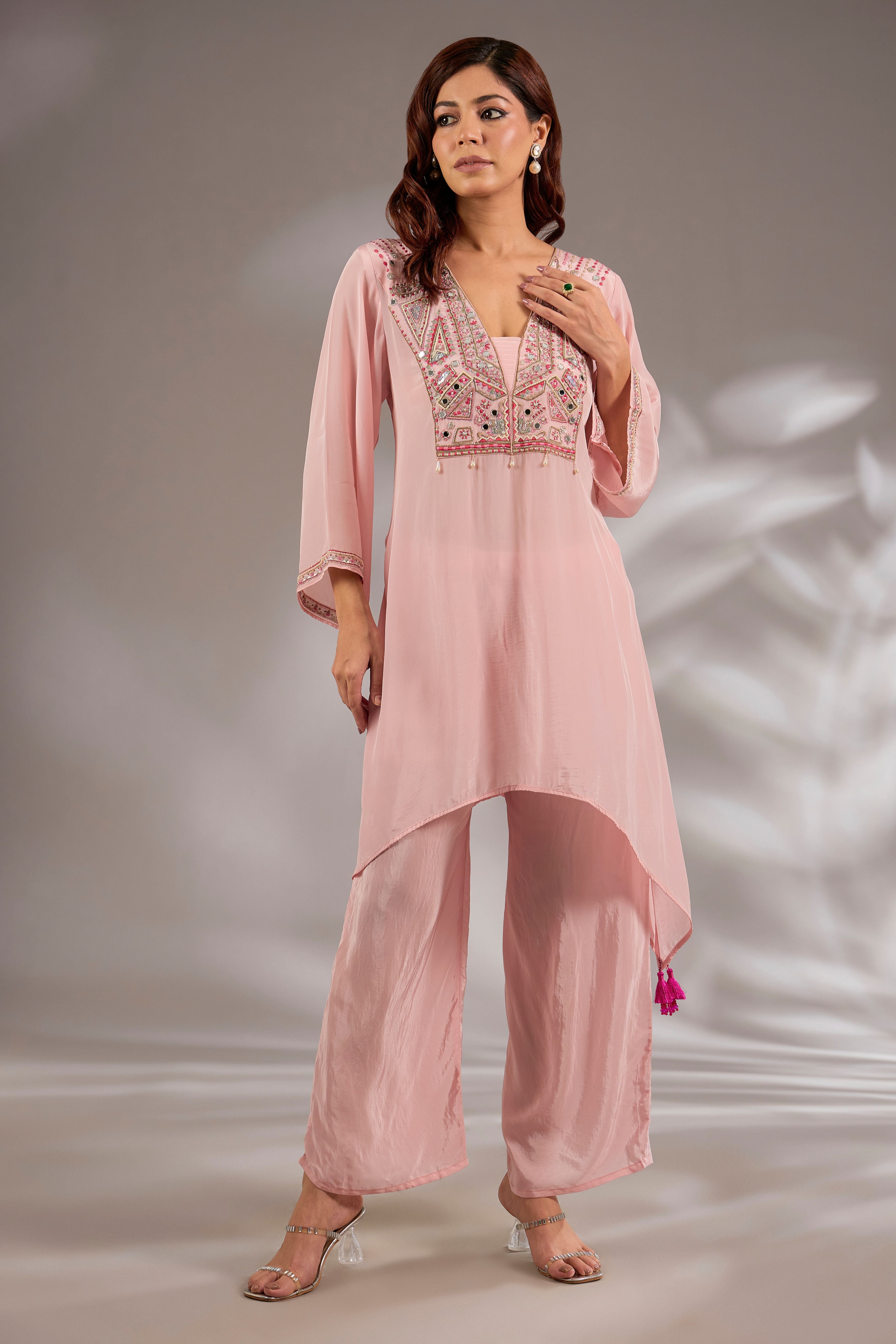 Kurta in crepe base with thread, cutdana and mirror embroidery.