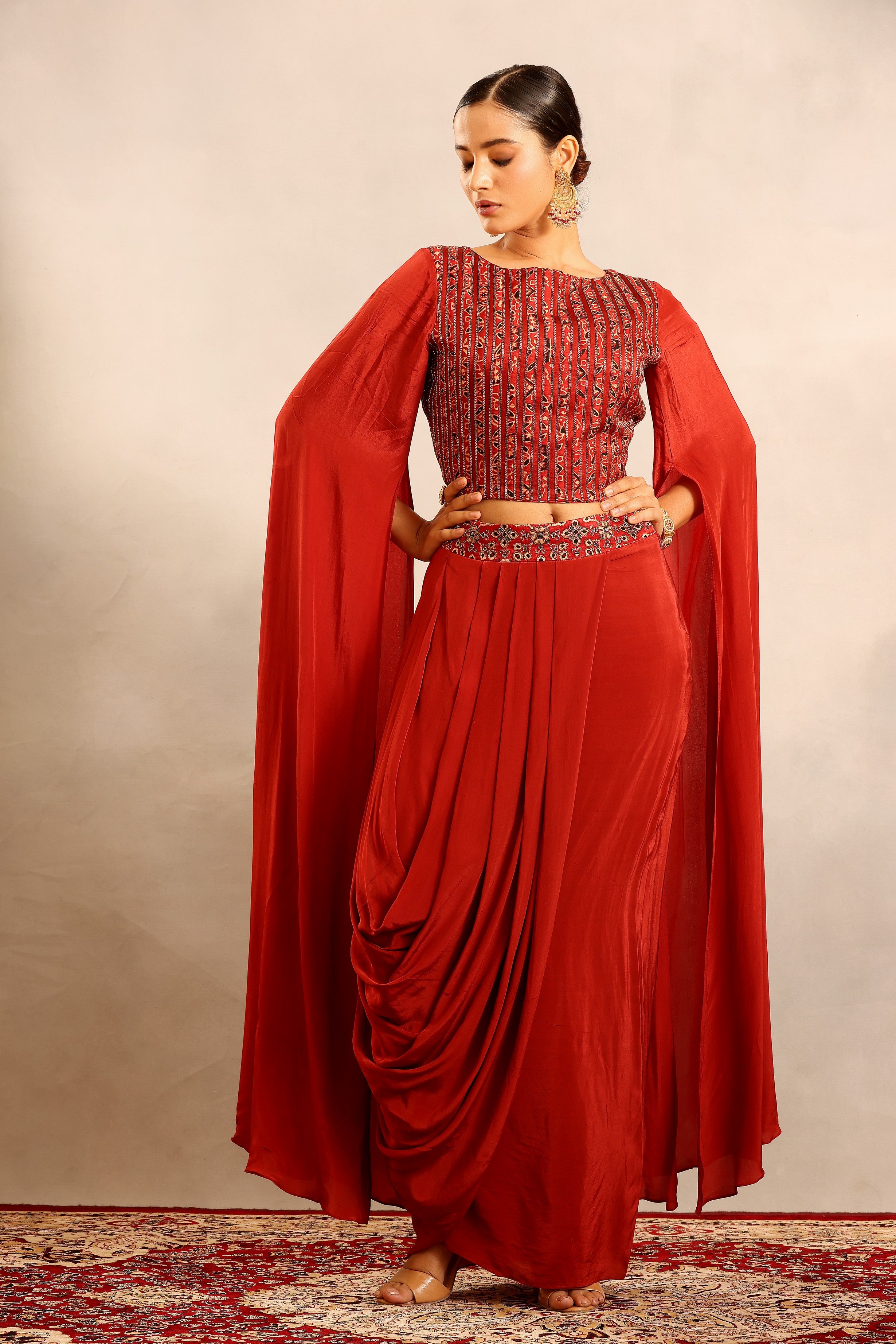 Red Ajrakh embroidered cape sleeve blouse with drape skirt
