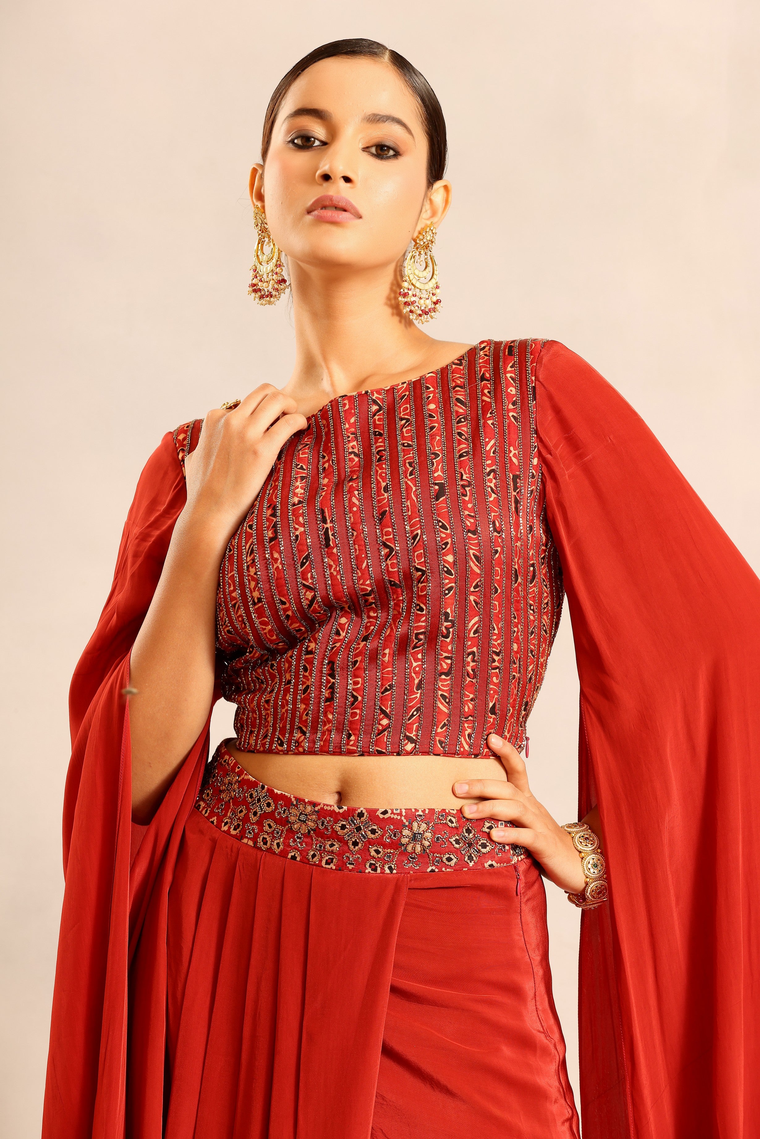 Red Ajrakh embroidered cape sleeve blouse with drape skirt