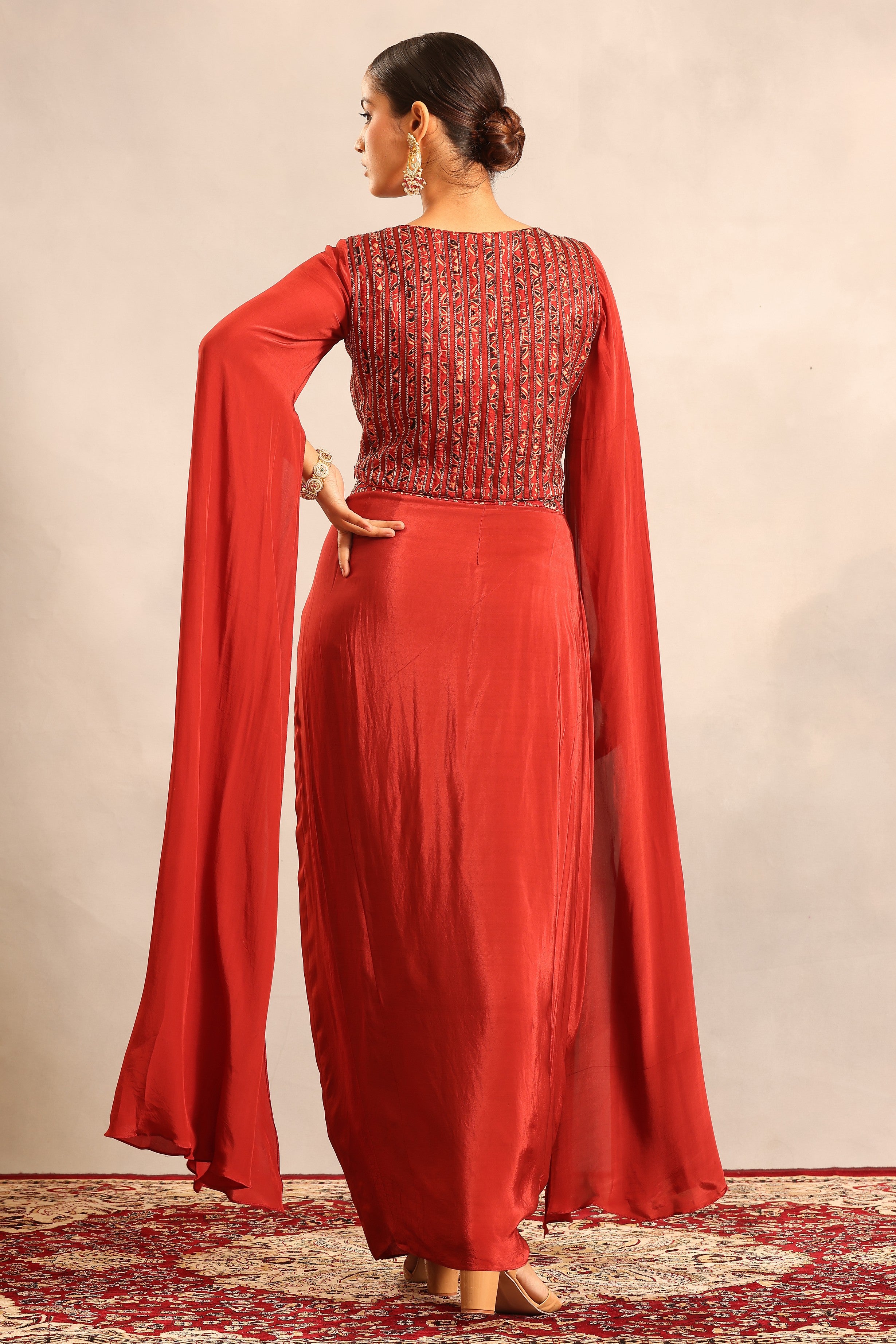 Red Ajrakh embroidered cape sleeve blouse with drape skirt
