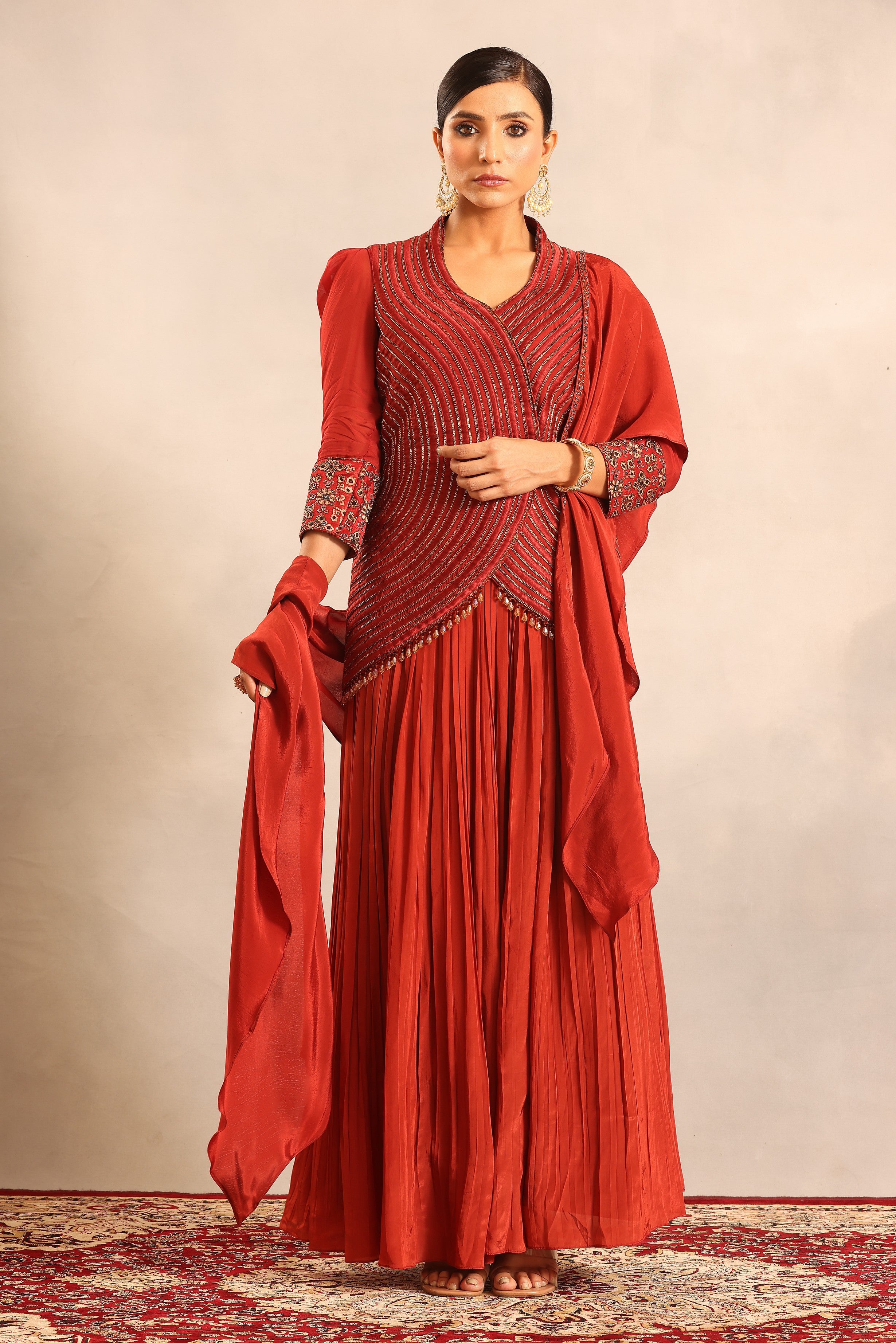 Red strip embroidered overlap jacket with pleated skirt and ruffled dupatta