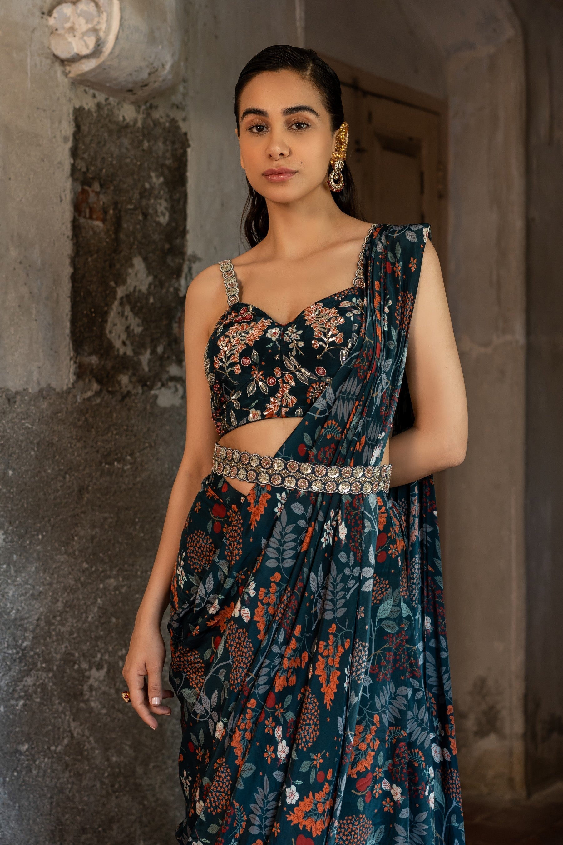 A draped indo western saree set paired with bustier and style with belt