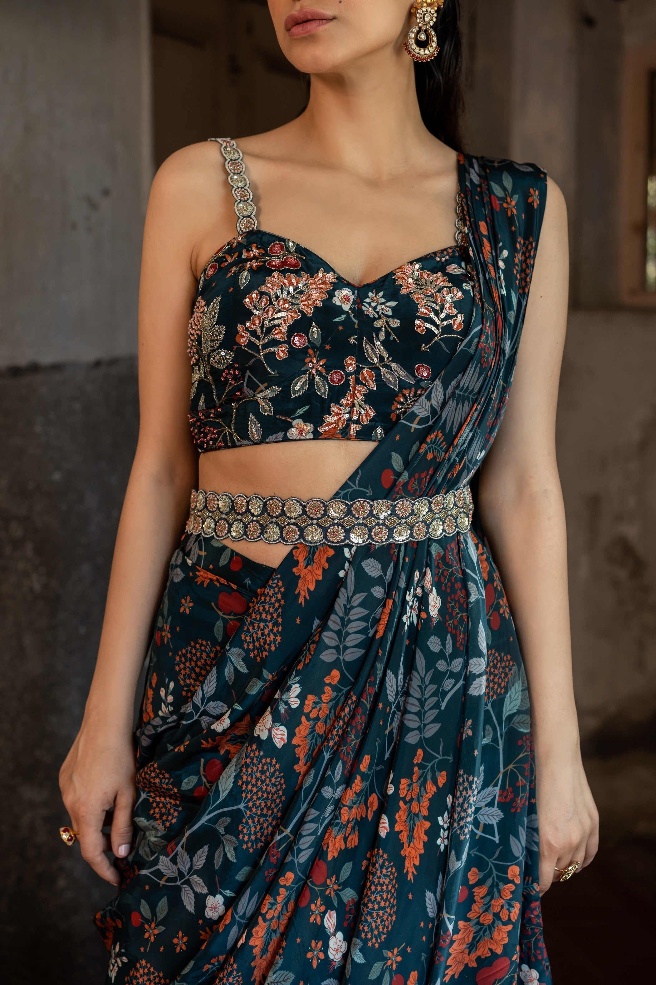 A draped indo western saree set paired with bustier and style with belt